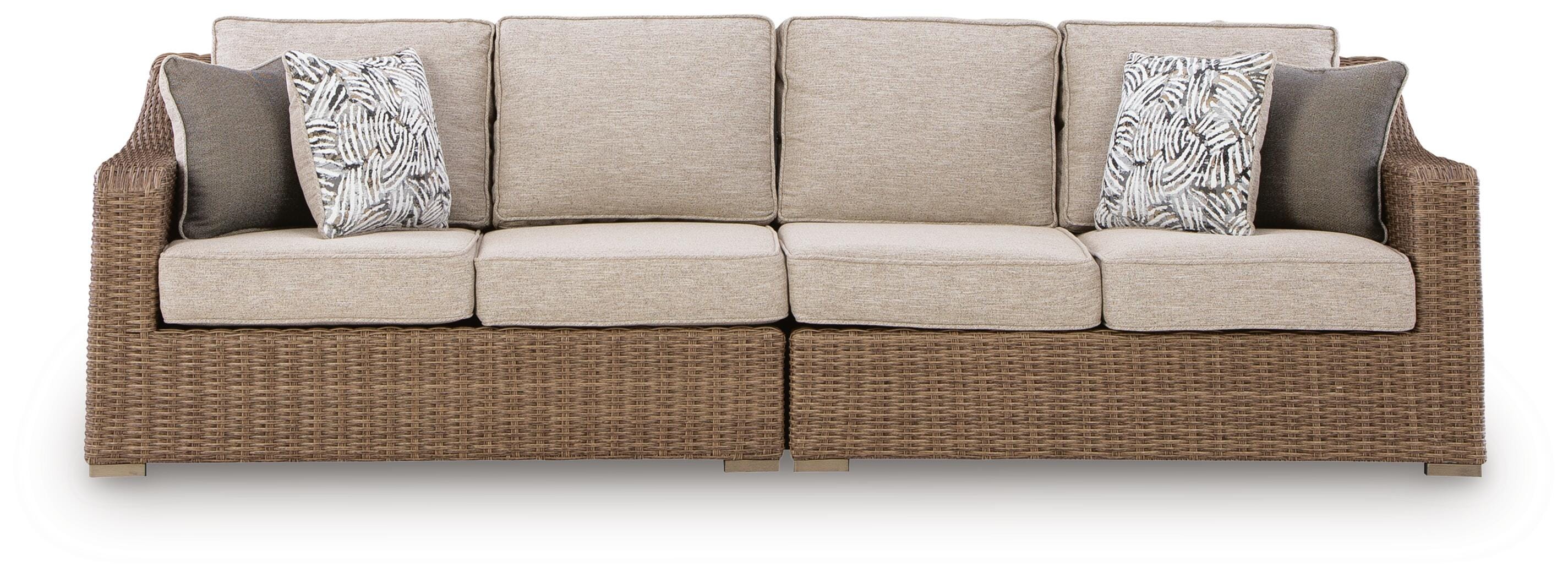 Beige sectional sofa with wicker frame on a white background