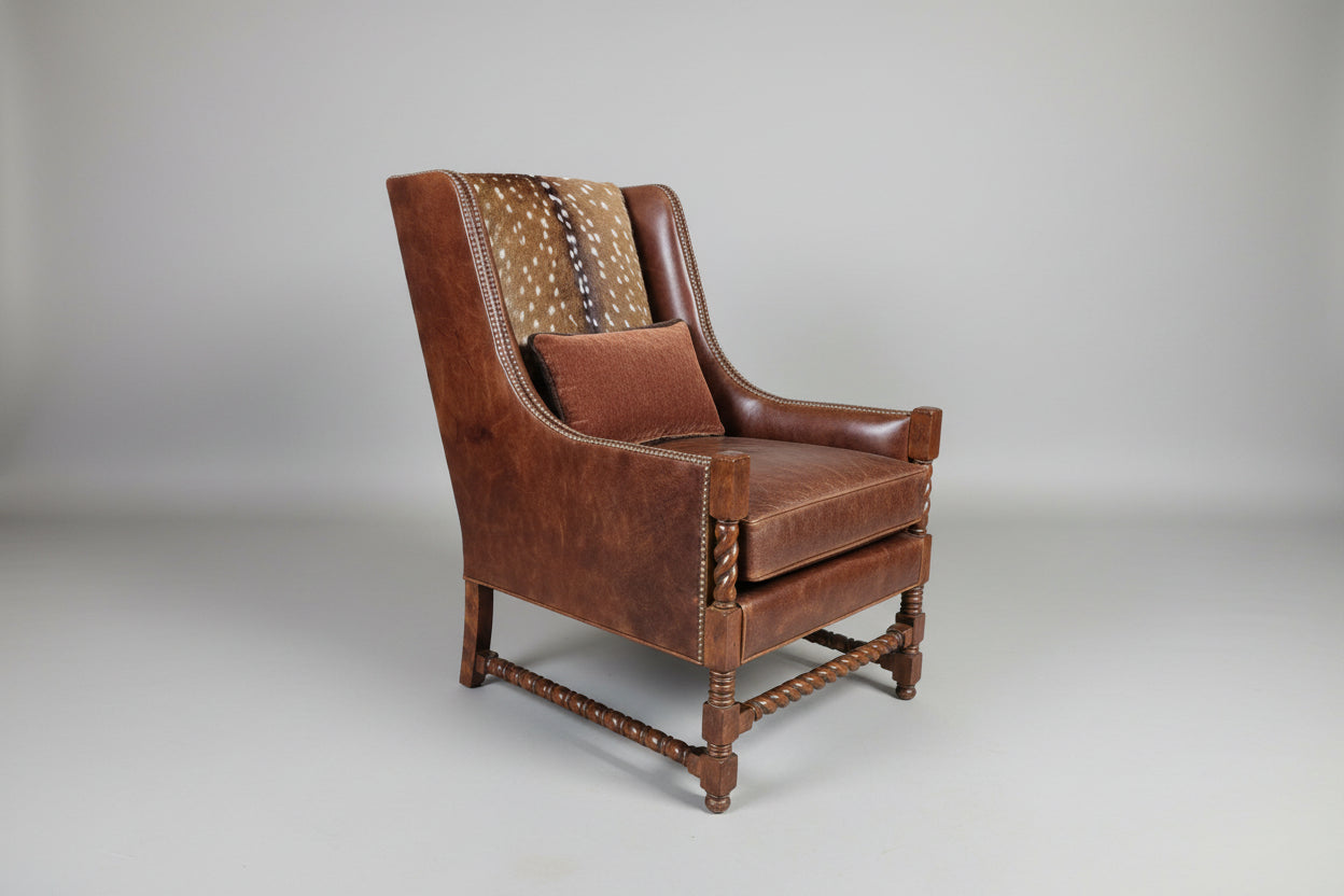 Brown leather armchair with patterned backrest on a gray background