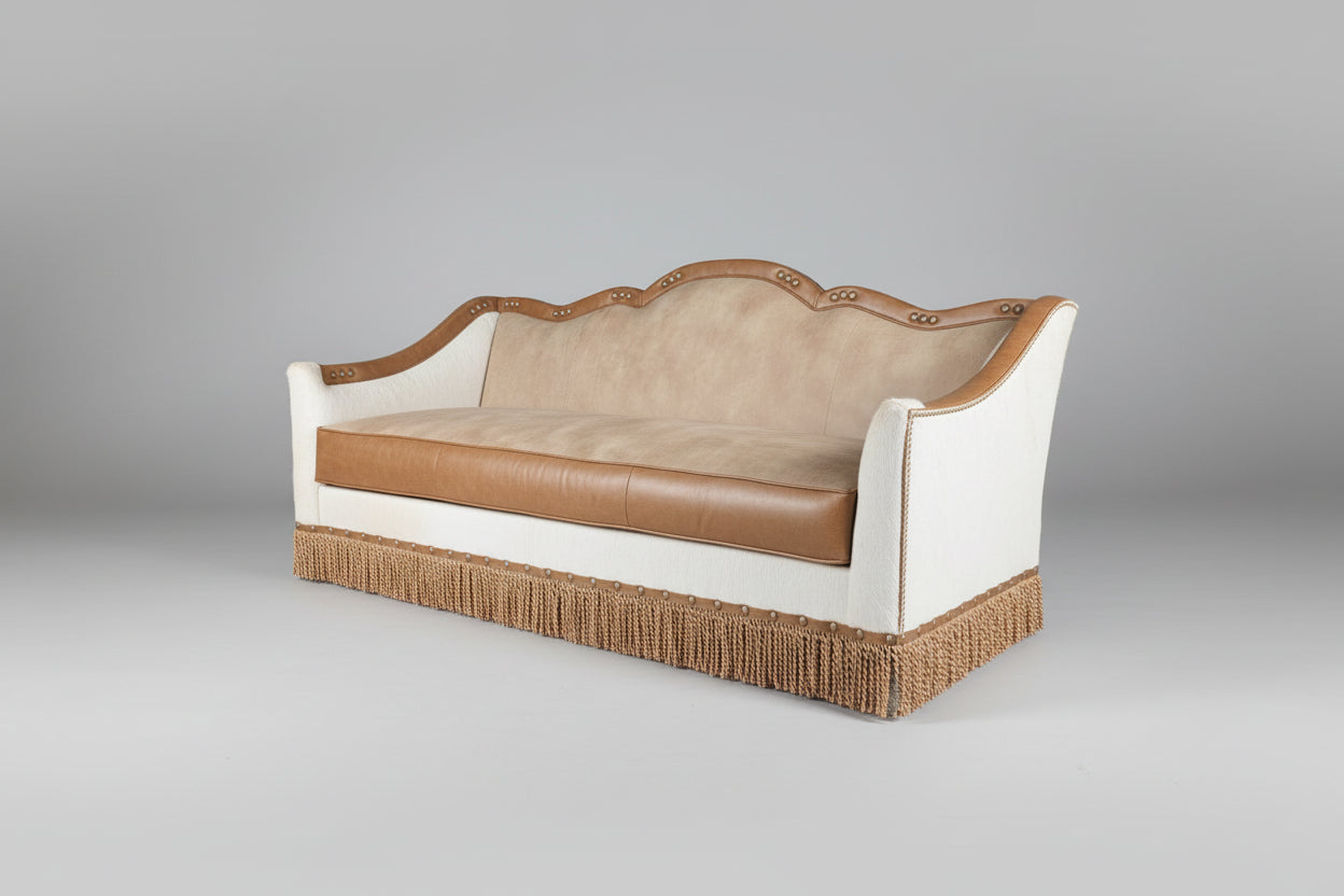 Decorative sofa with brown leather and white fabric on a gray background