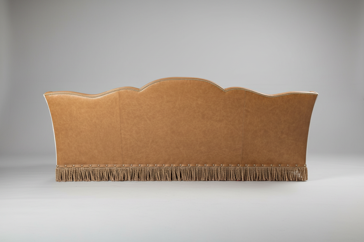 Beige upholstered headboard with fringe on a gray background