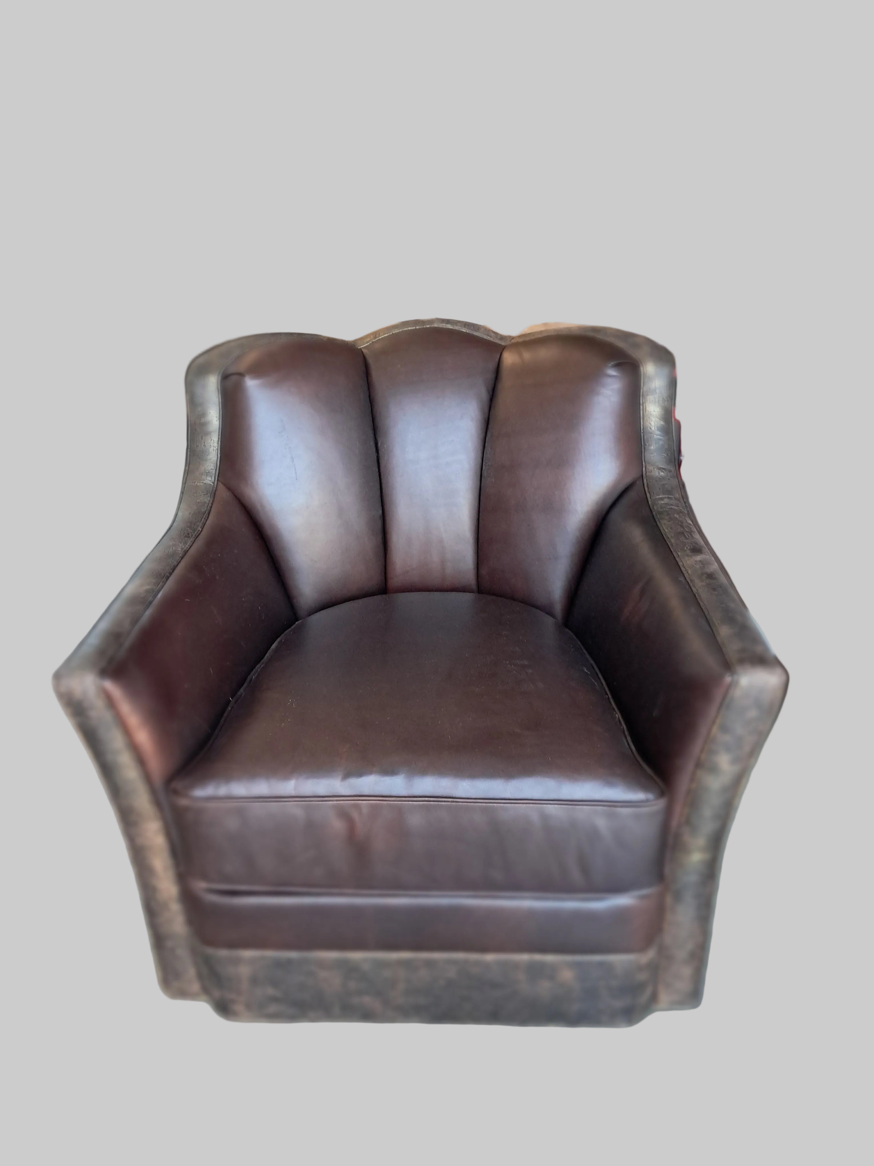 Brown leather chair in a warehouse setting with boxes and equipment in the background