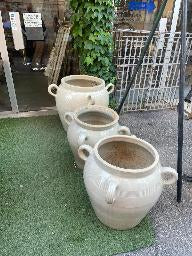 Pair of greige glazed confit pots with looped handles in graduated sizes
