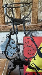 Wrought iron champagne bucket stand with a scrolled body and ringed top
