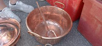 French copper jam pan with brass rim handles and its long handled copper spoon