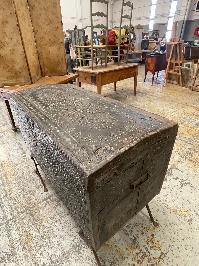 17th century leather covered iron bound trunk with a dark pitted textured surface
