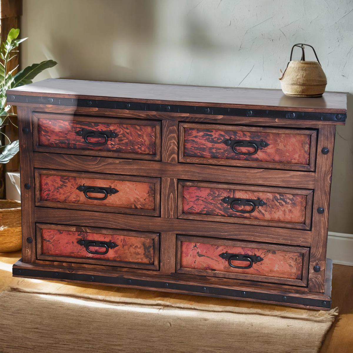 Wooden dresser with distressed finish and copper panels in a room setting