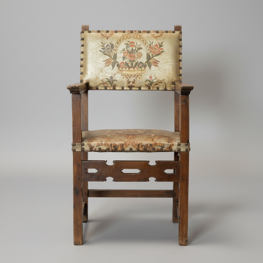 A vintage wooden armchair with a floral tapestry upholstered seat and backrest, photographed against a neutral light gray background.