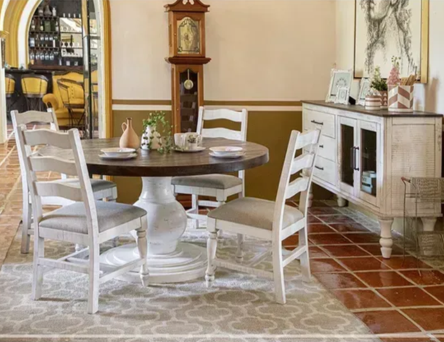 A hacienda style dining room with a round white dining table and chairs at Fiesta Furnishings in Scottsdale, AZ.