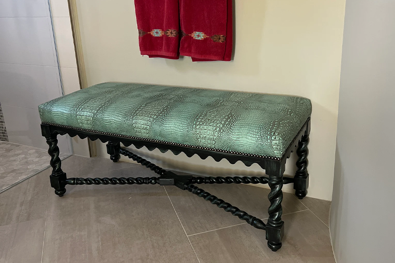 A unique leather bench in a bathroom at Fiesta Furnishings.