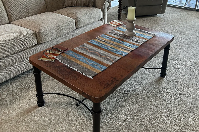 A copper table in a customer home from Fiesta Furnishings.