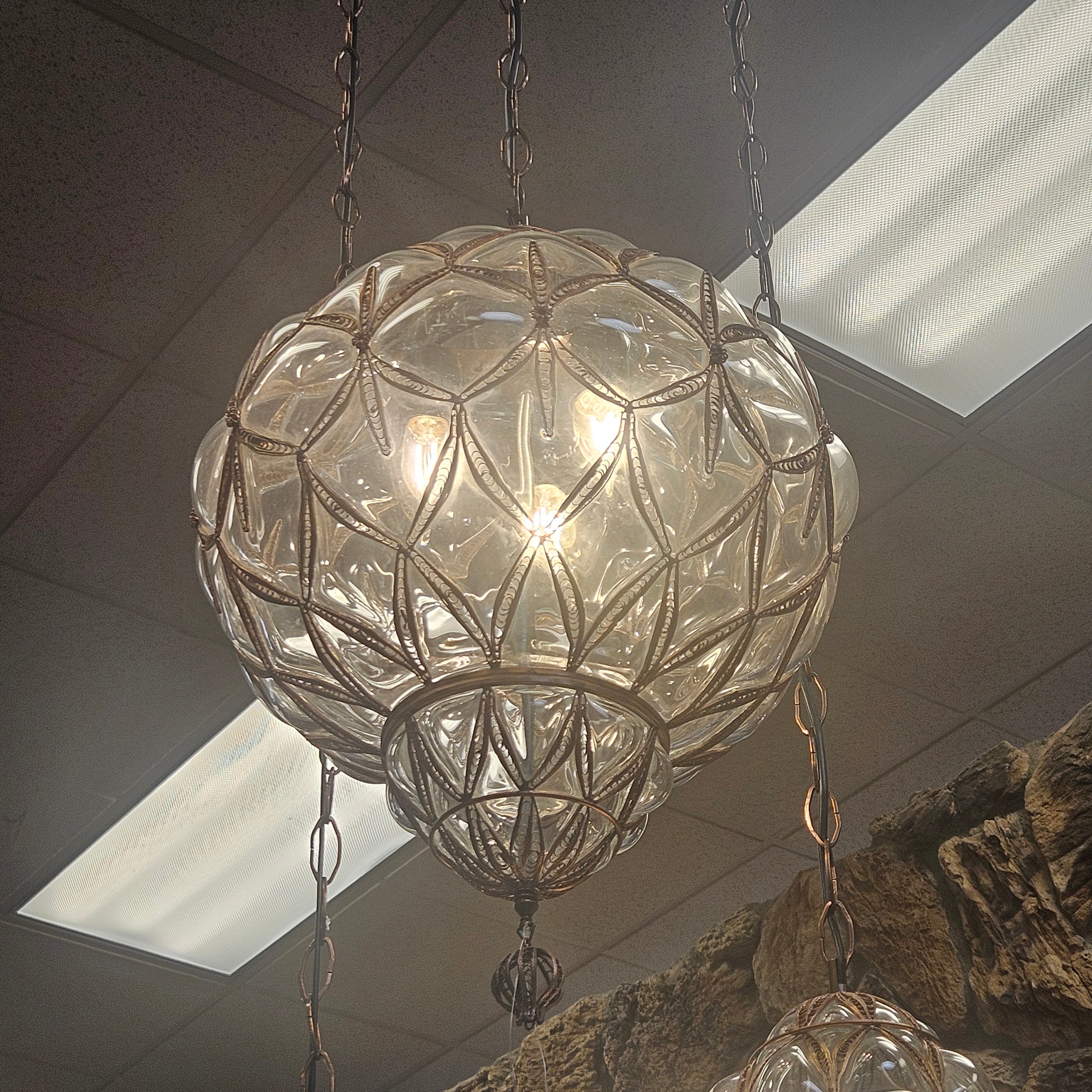 Decorative ceiling light fixture with glass and metal design.