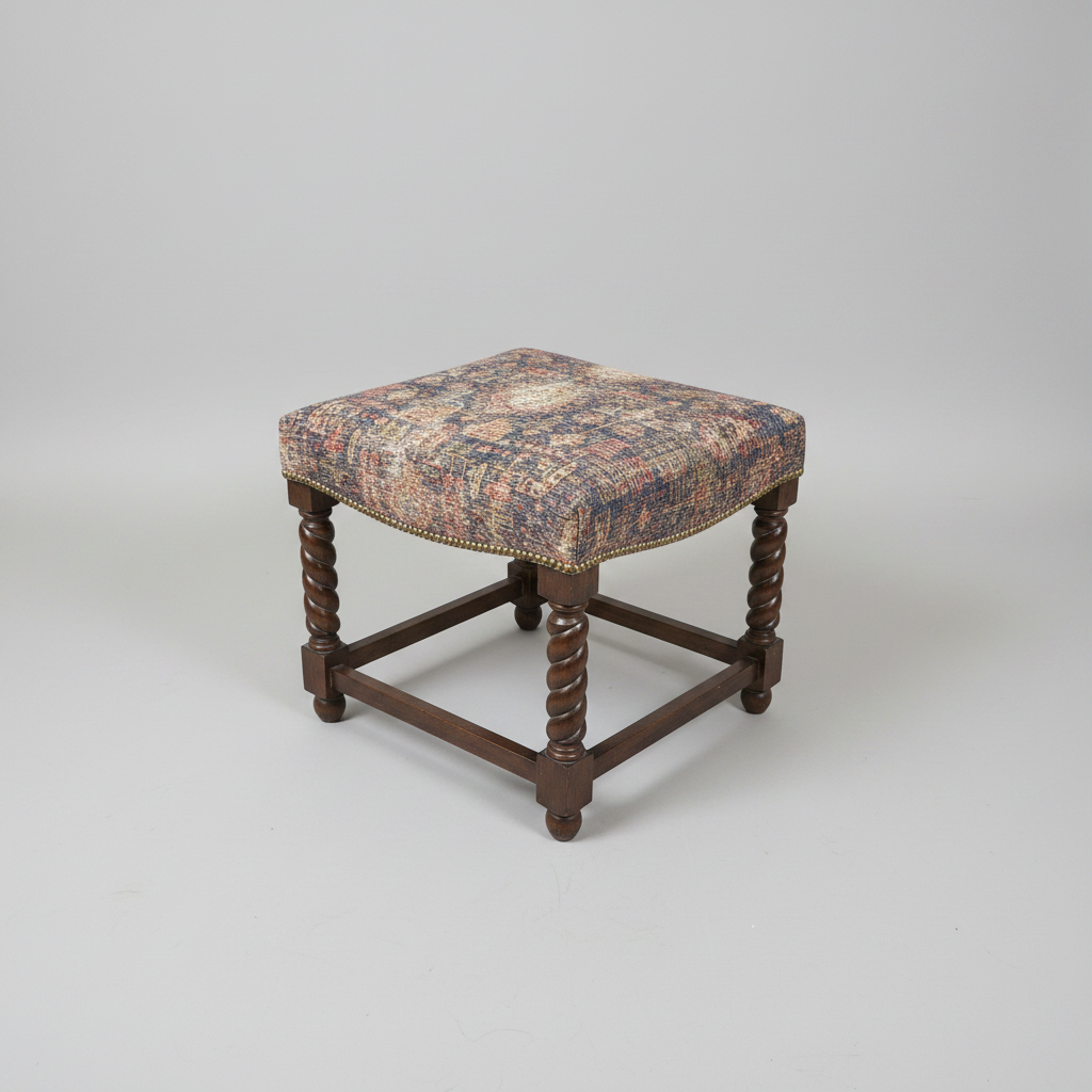 Decorative stool with patterned seat and wooden legs on a textured rug, with a round wooden table and sofa in the background.