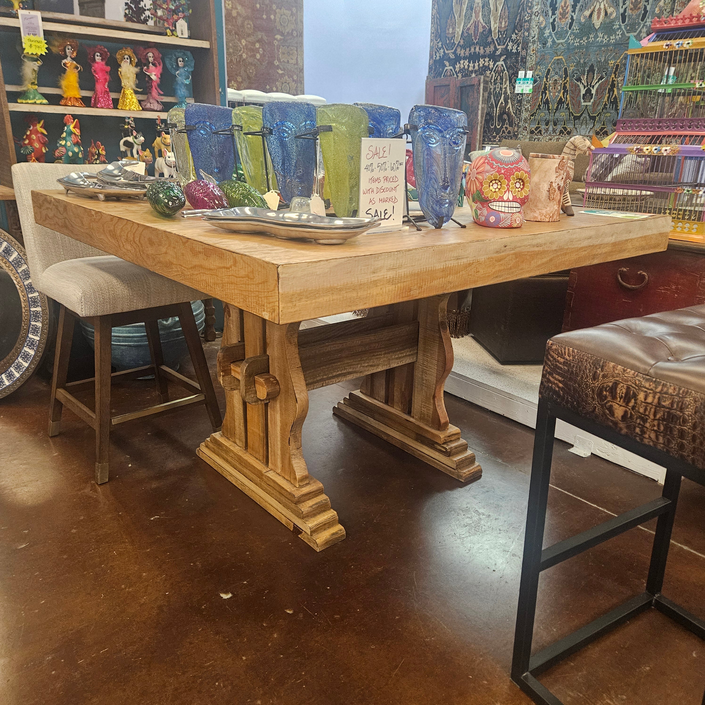 Wooden table with various items on a dark floor