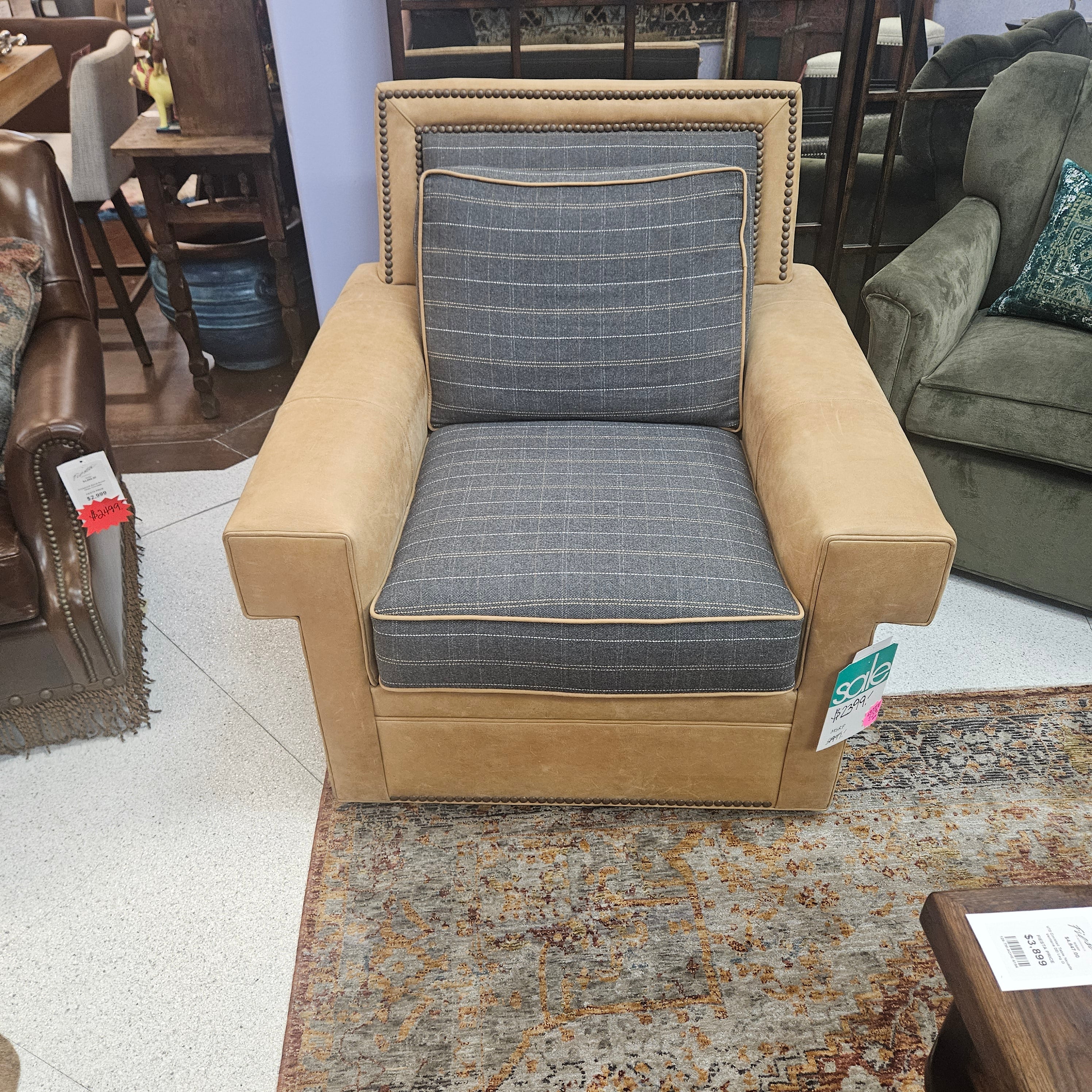 Beige armchair with gray cushion in a furniture store setting