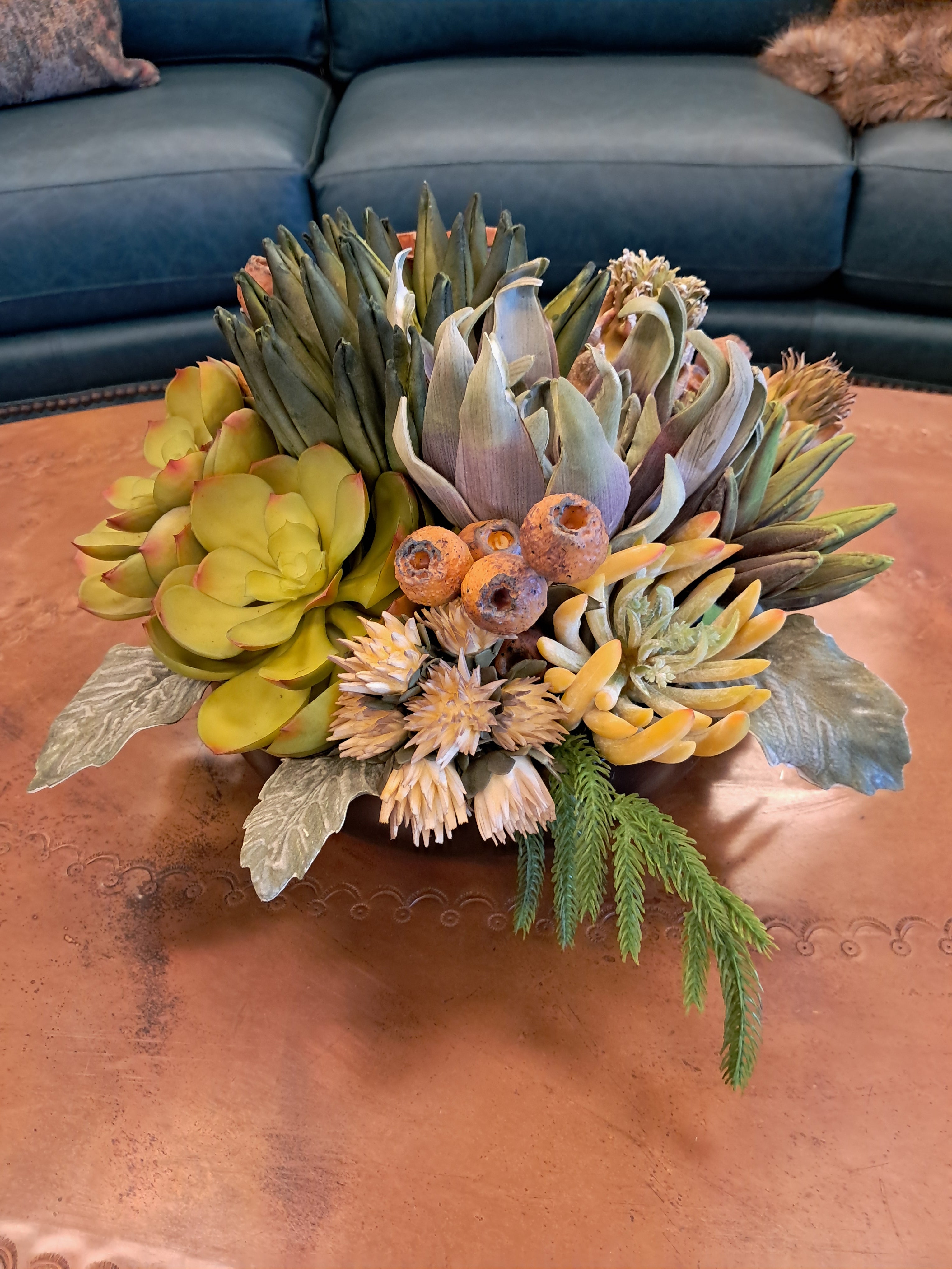 Bouquet of succulents and greenery on a textured surface