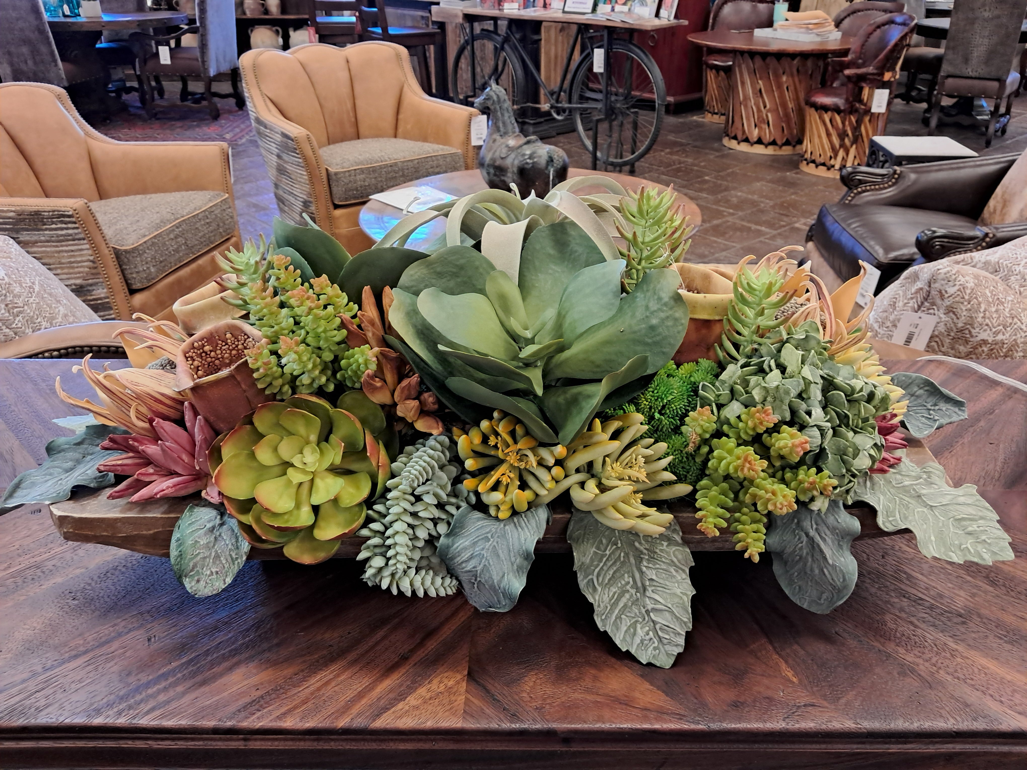 Collection of artificial plants on a wooden surface