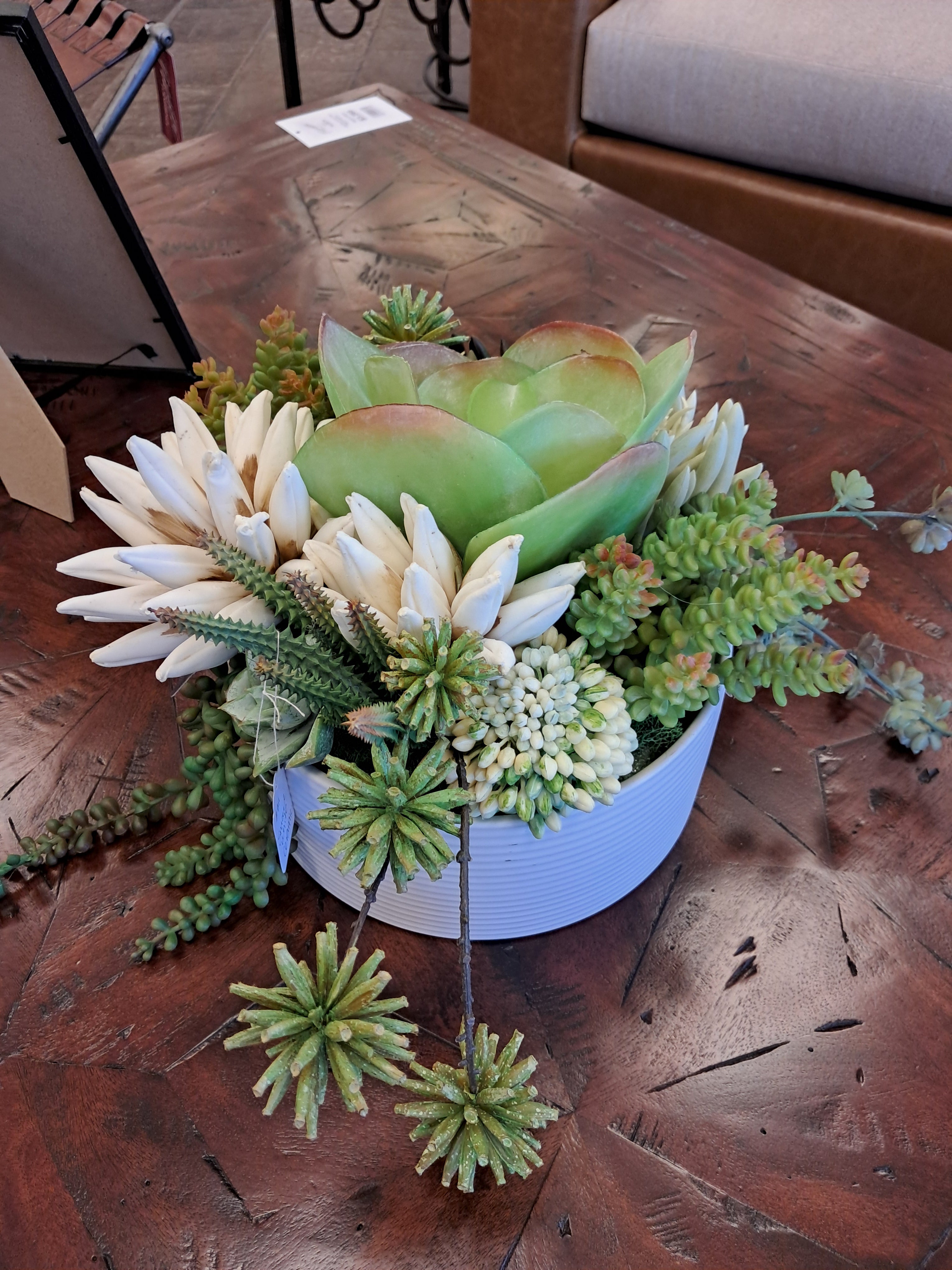 Bouquet of succulents on a textured wooden surface