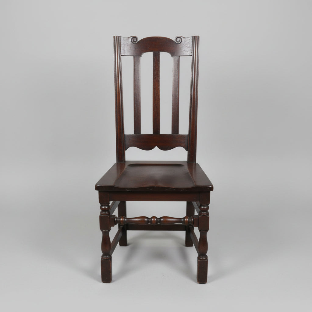 Wooden chair on a tiled floor with other chairs and tables in the background