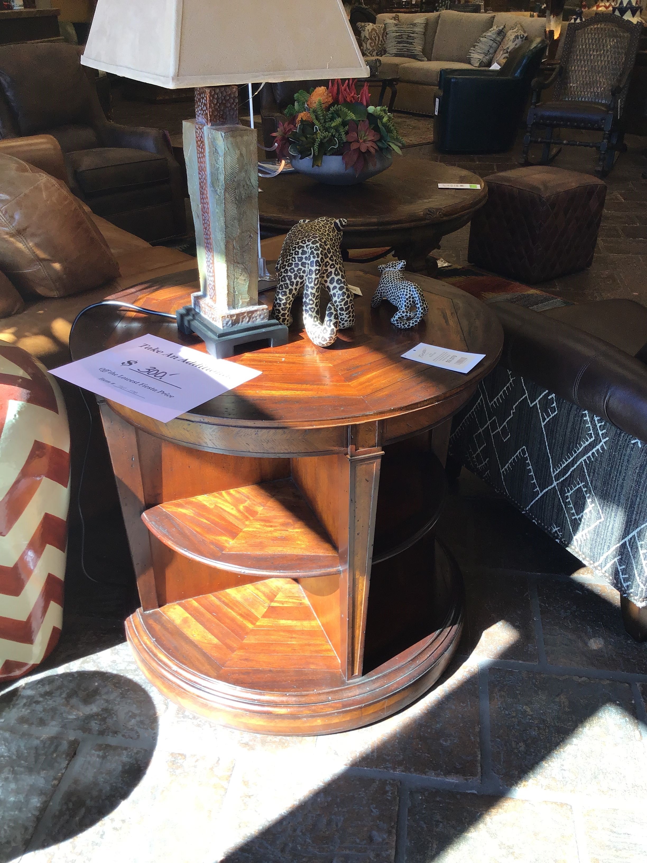 Wooden side table with decorative items in a furniture store setting