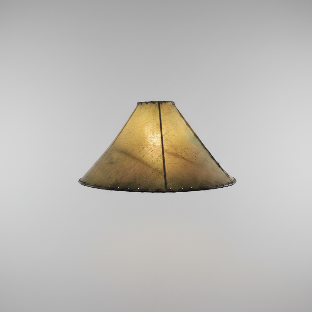 Vintage-style lamp with a textured green shade on a pink wall.