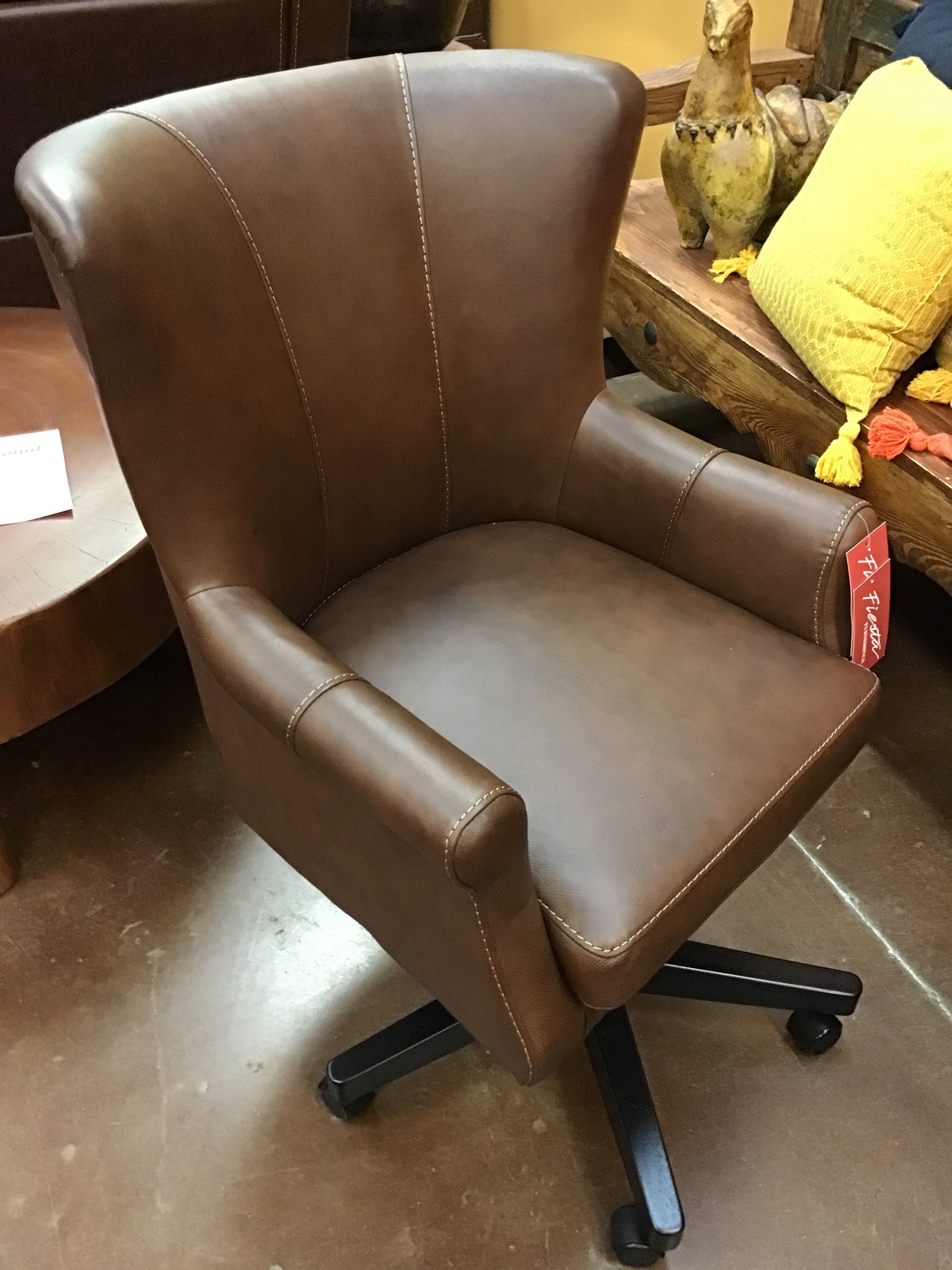 Brown leather office chair with wheels in a room setting