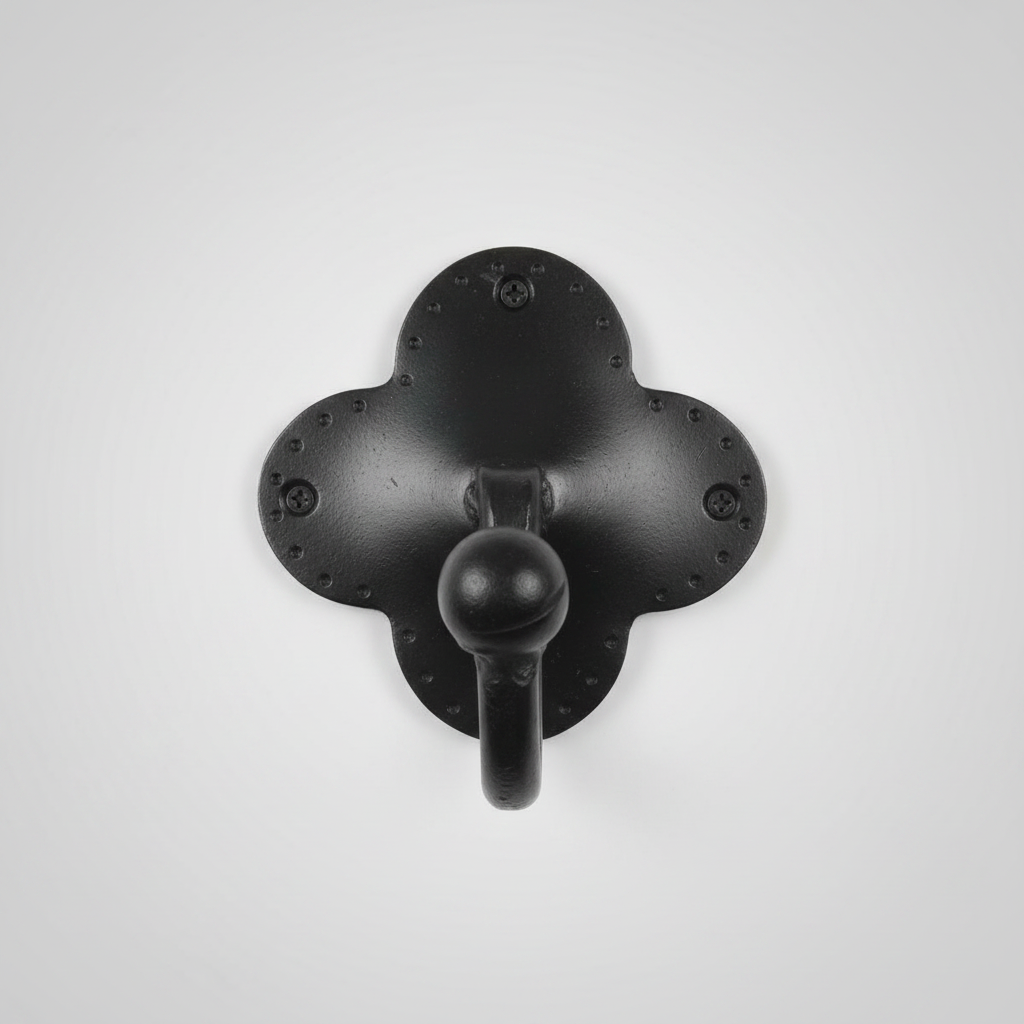Black metal wall hook with decorative elements on a white background