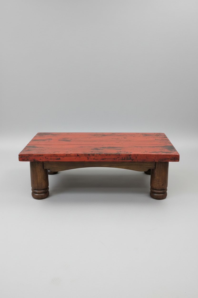 Wooden table with a red top on a white background