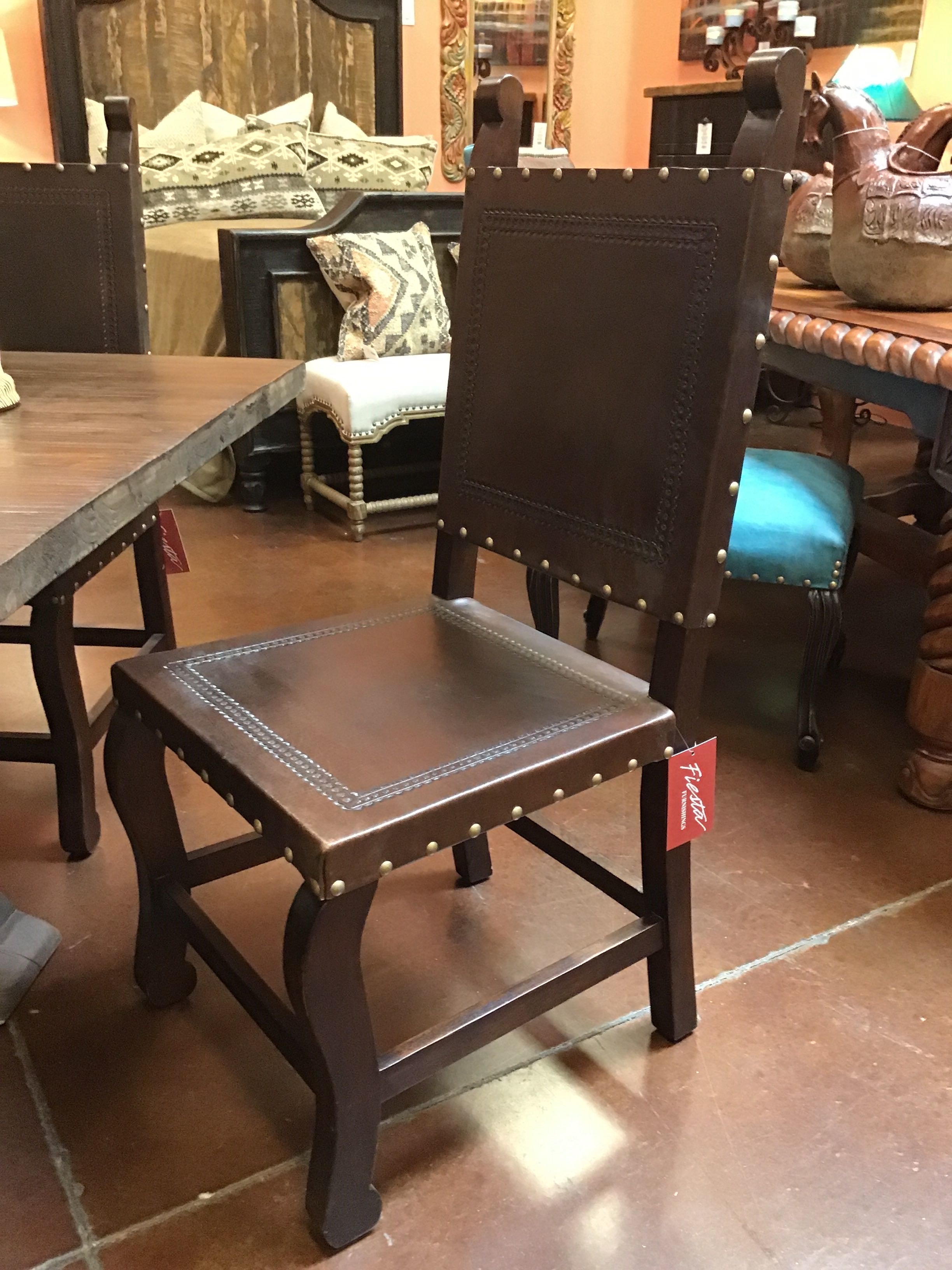 Brown chair with leather seat and backrest in a furniture store setting