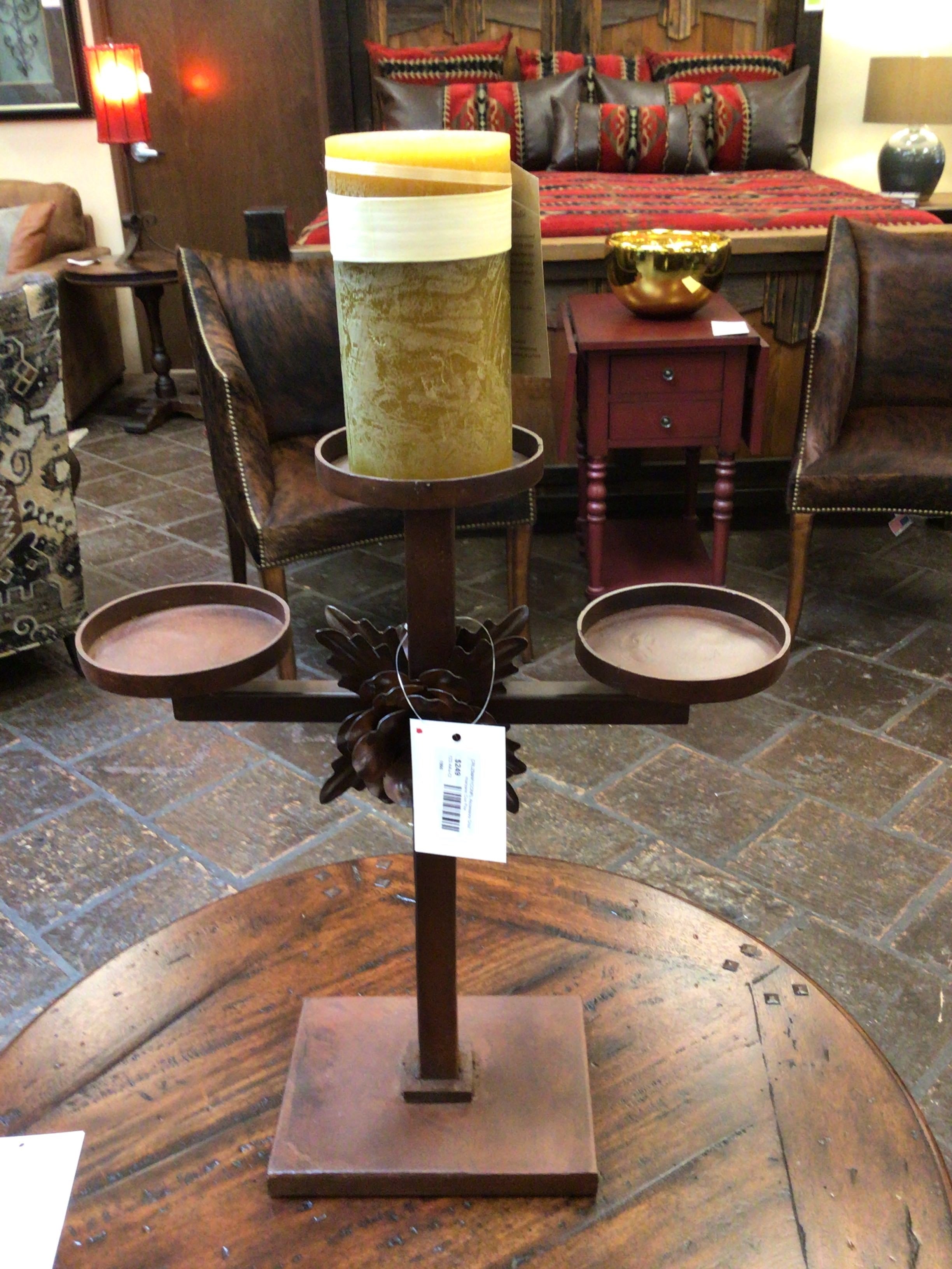 Decorative candle holder on a wooden table with a room in the background