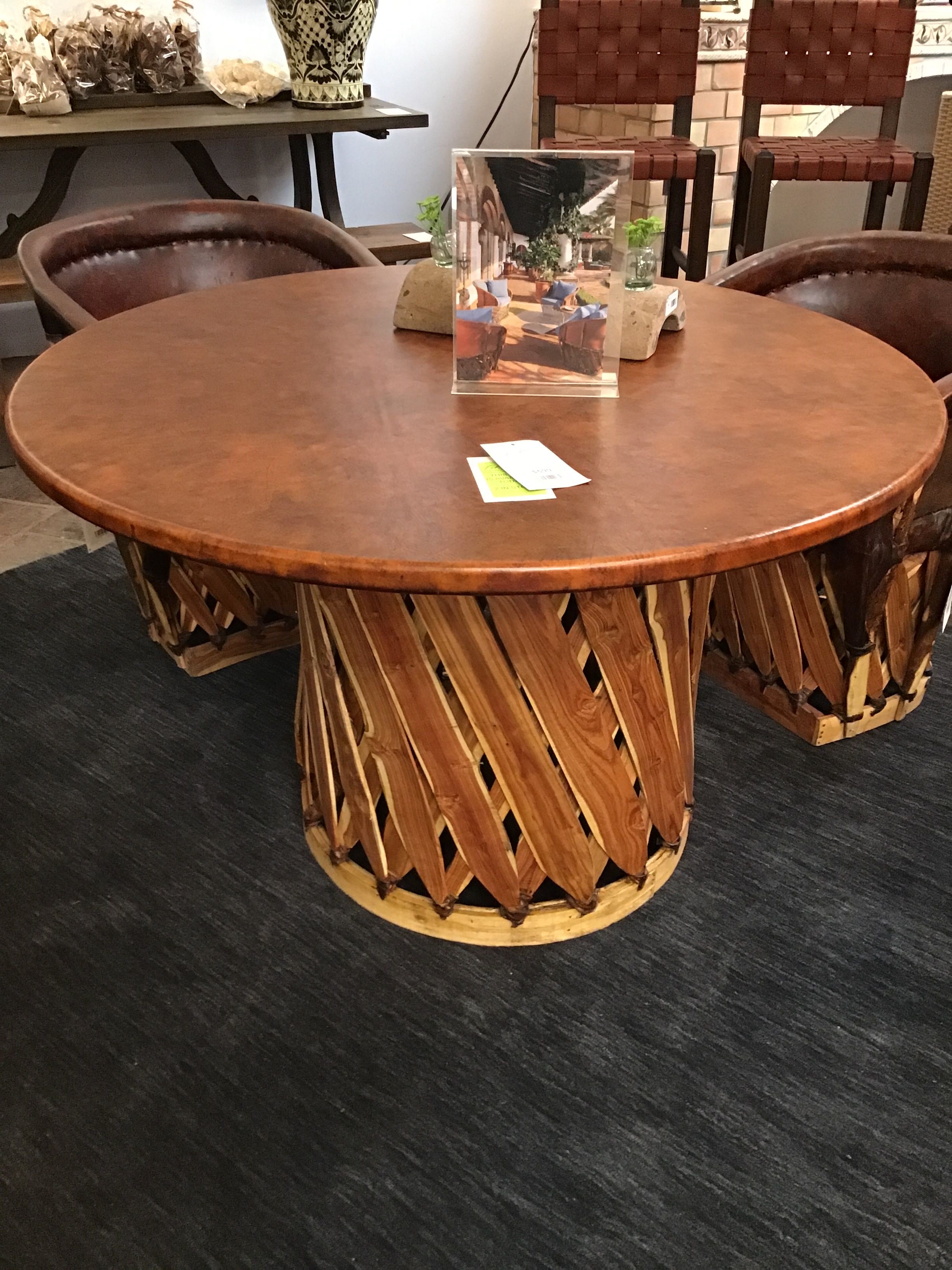 Wooden dining table with a textured base in a room setting