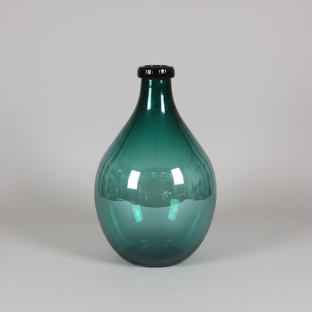 Green glass vase on a light gray background