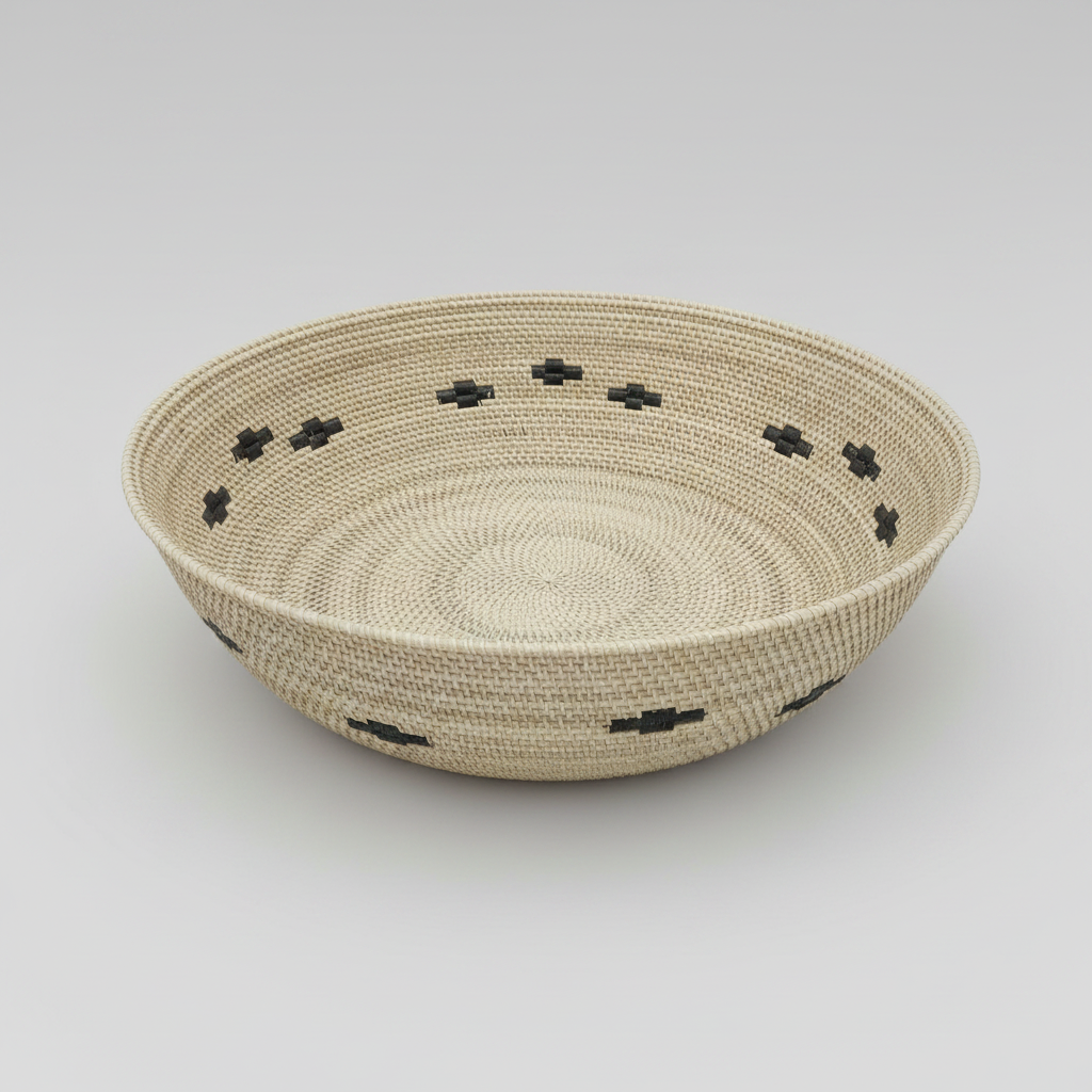 Woven basket with black decorative elements on a light gray background