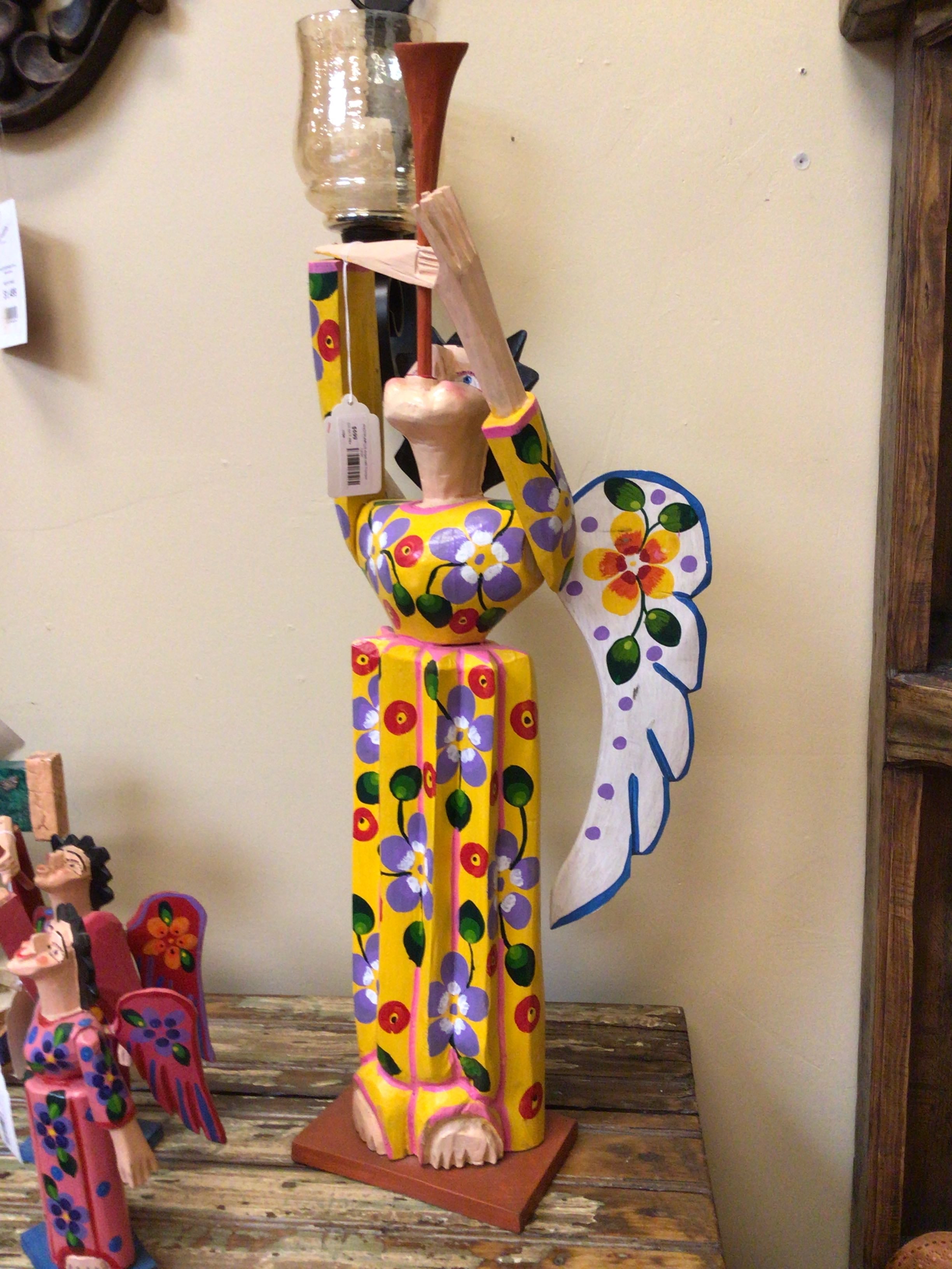 Colorful ceramic figure on a wooden surface with a neutral background
