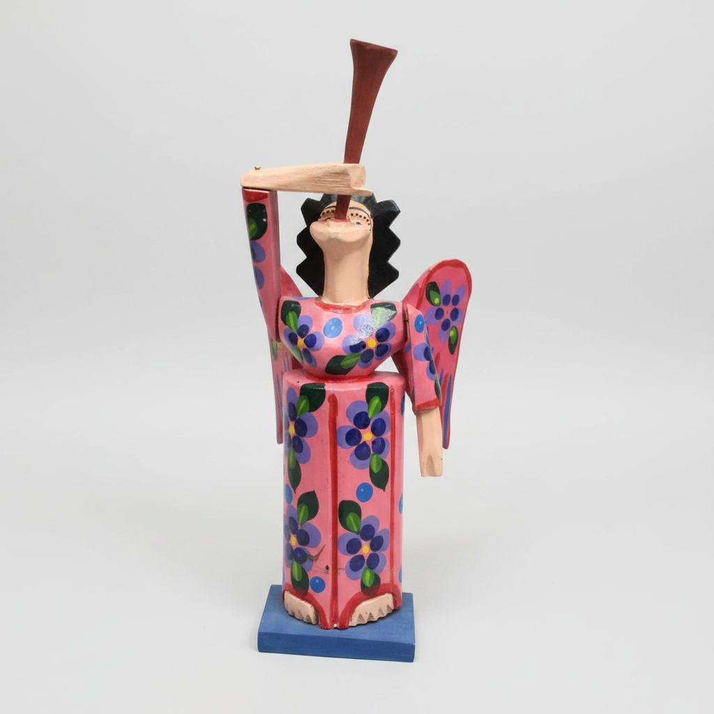 Colorful angel figurine with a tag on a wooden surface