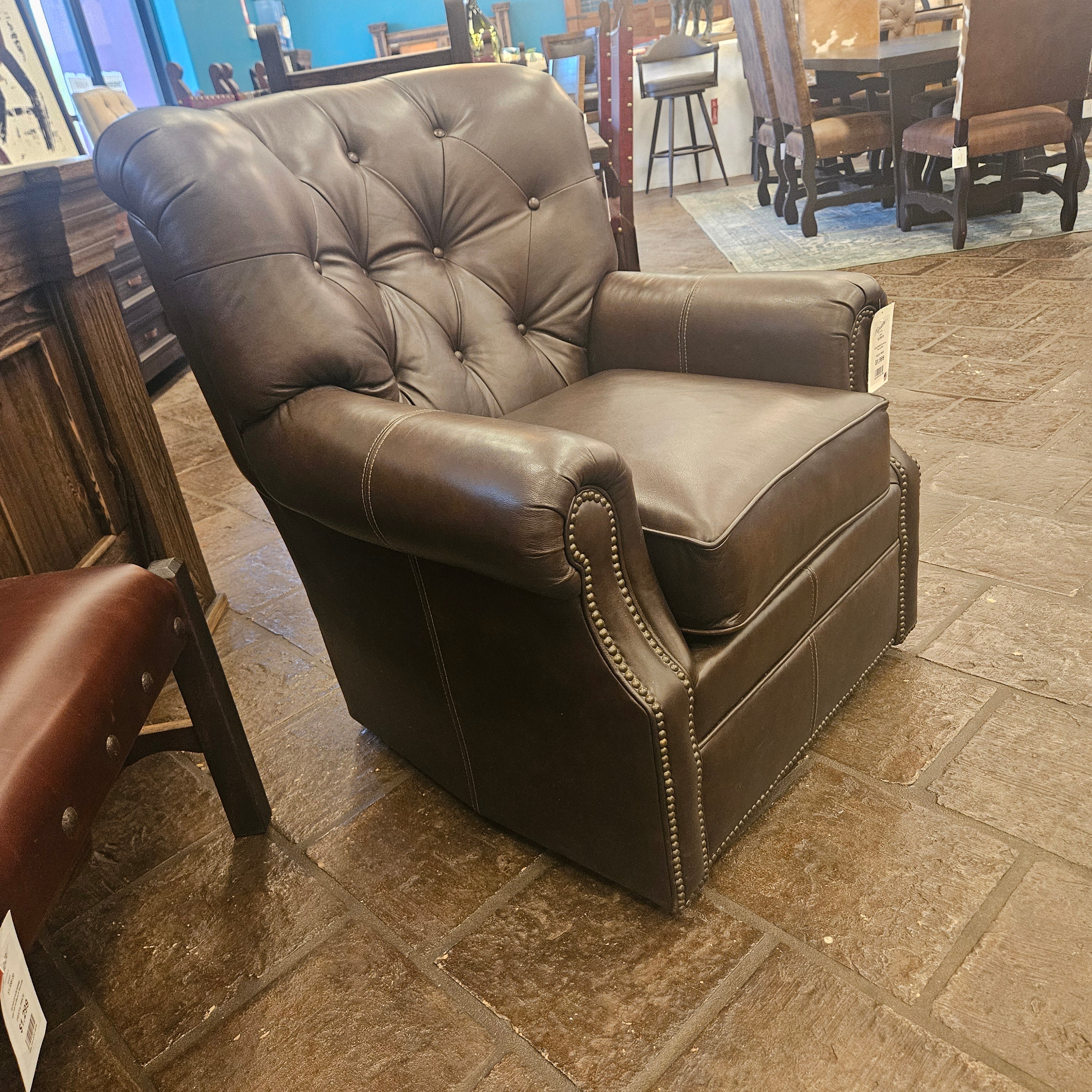 Brown leather chair against a stone wall