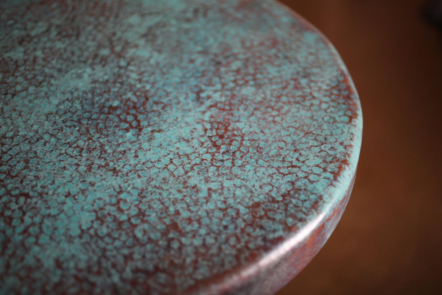 Close-up of a textured ceramic surface with a speckled pattern.