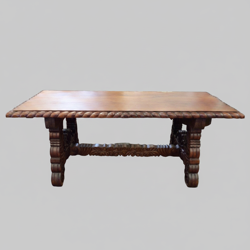 An antique dark wood rectangular table with a carved rope-tied apron and turned legs, shown against a solid gray background.