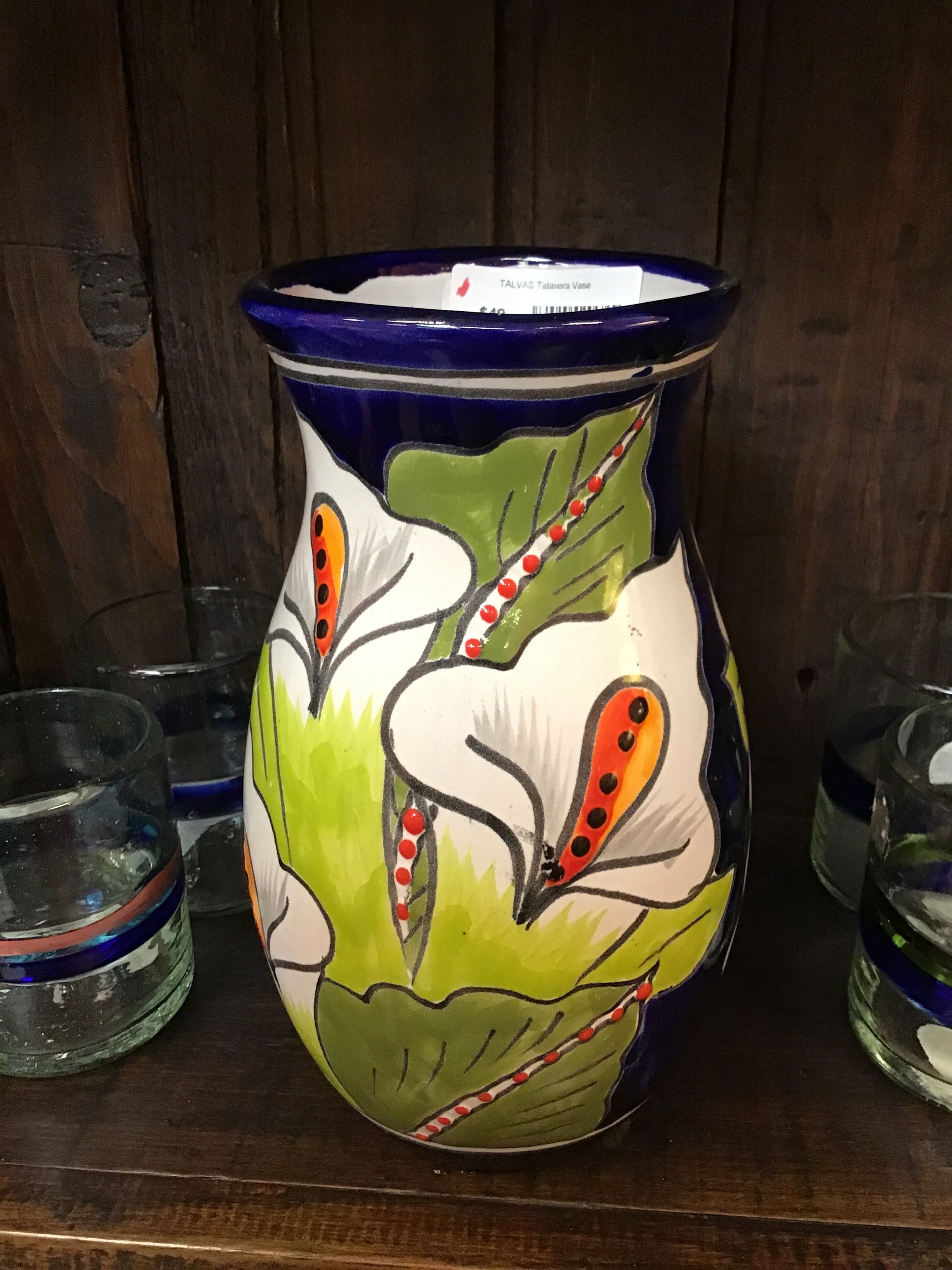 Decorative vase with floral design on a wooden surface