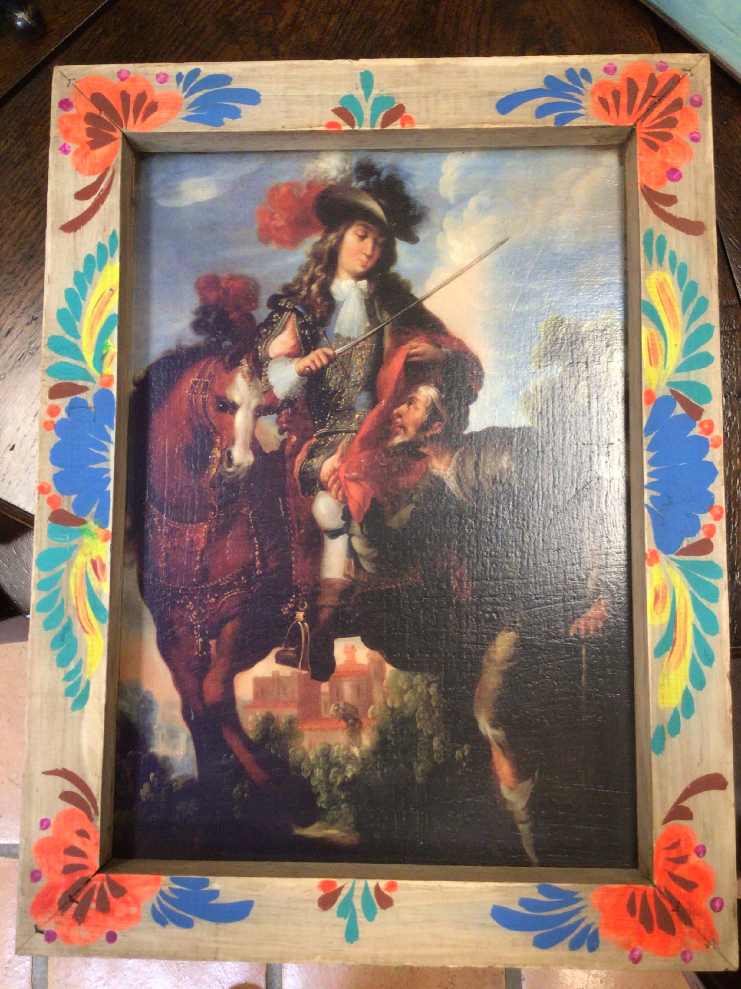 Vintage painting of a man on horseback with a colorful floral frame.