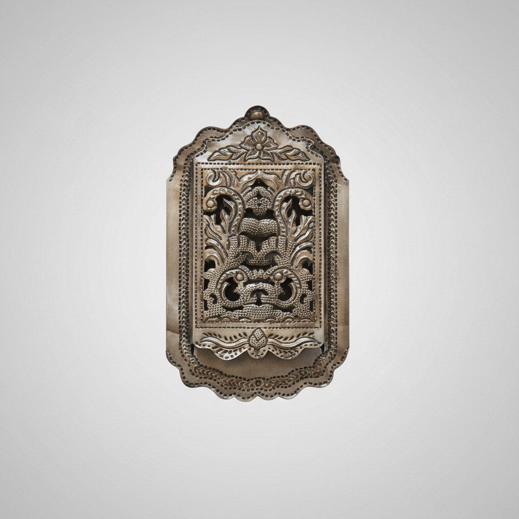 Decorative wall art pieces on a white wall with a red couch and wooden door in the background.