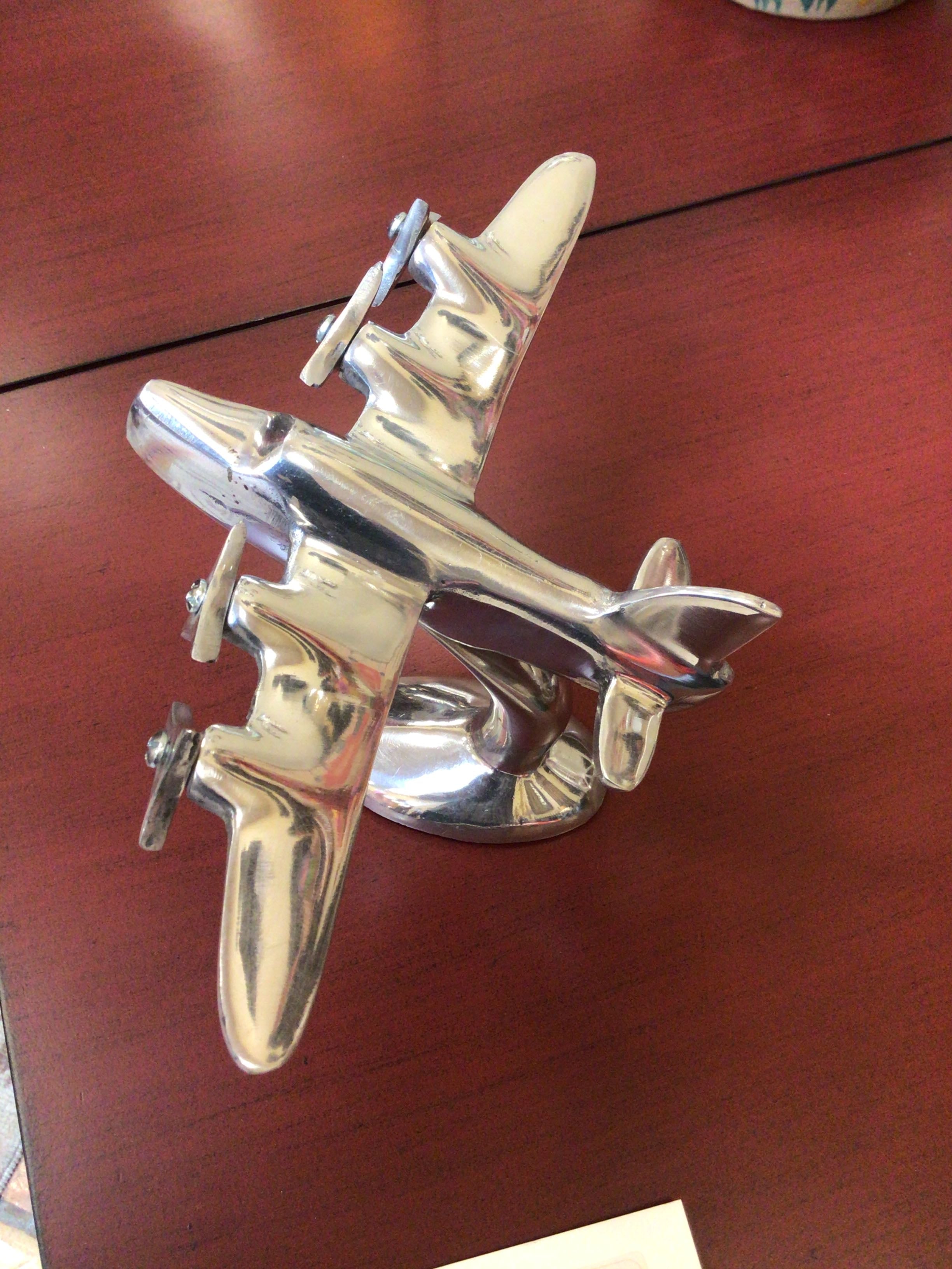 Metallic airplane ornament on a wooden surface