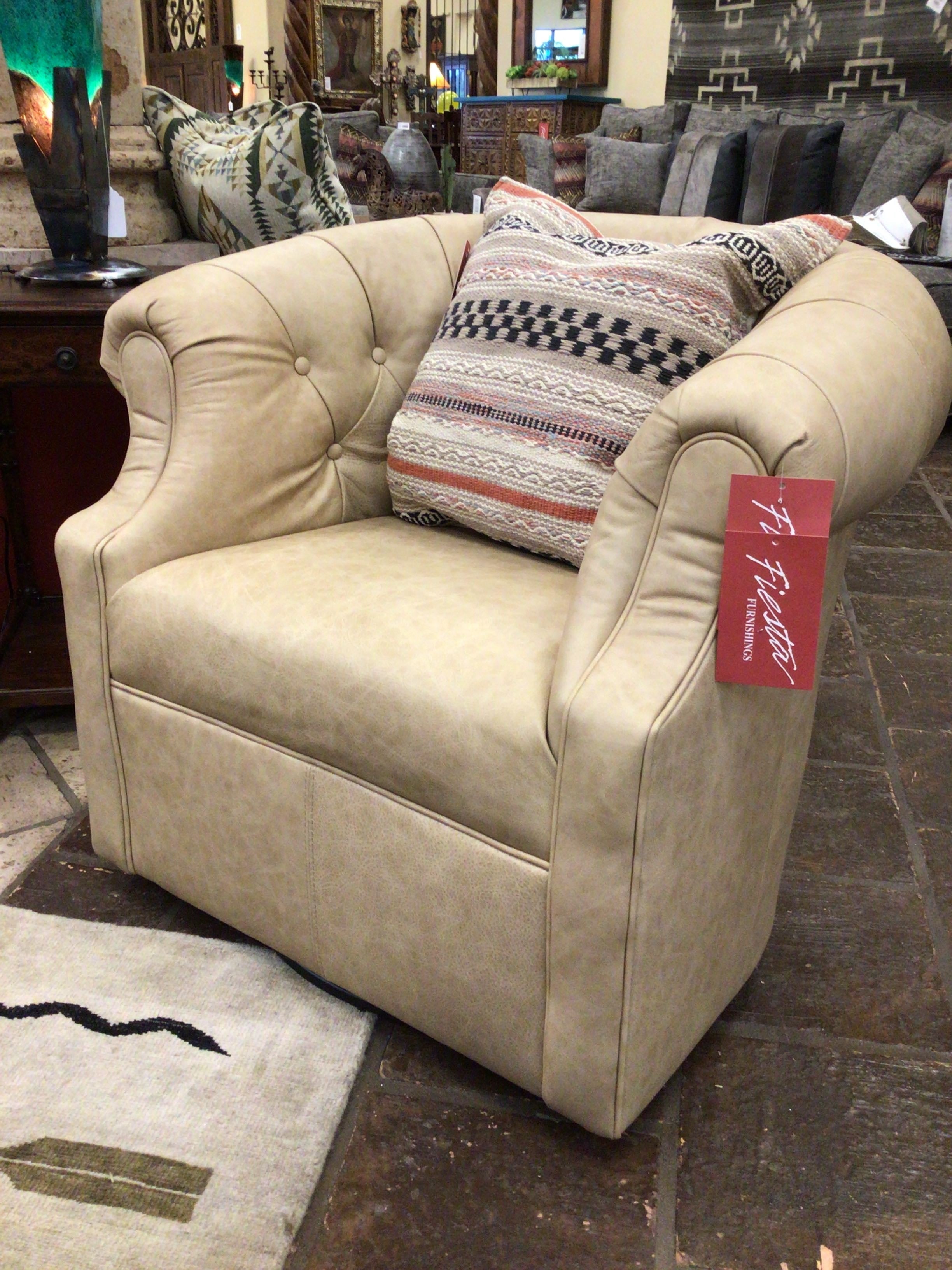 Beige armchair with a decorative pillow and a tag in a showroom setting.