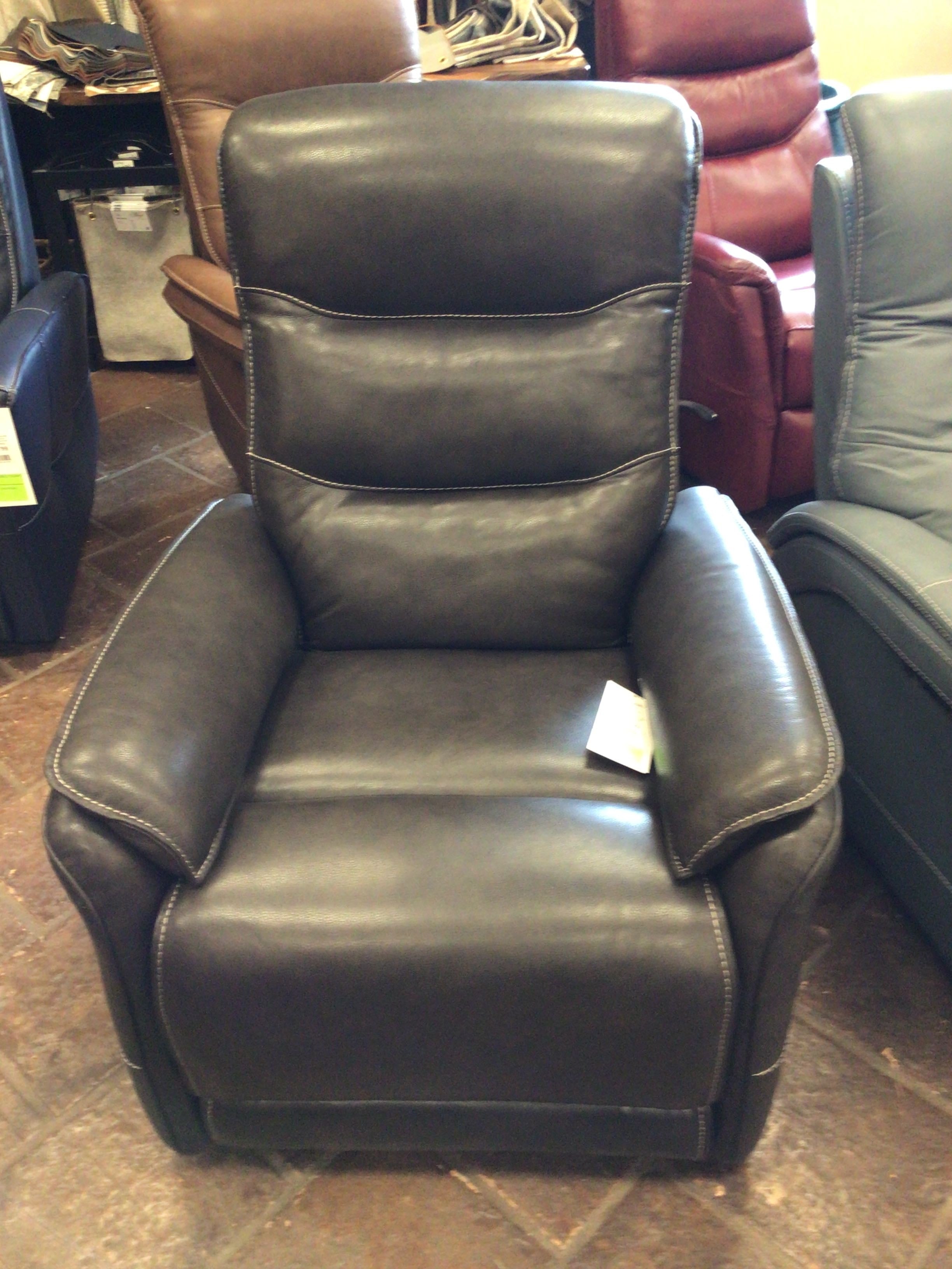 Brown leather recliner chair in a showroom setting