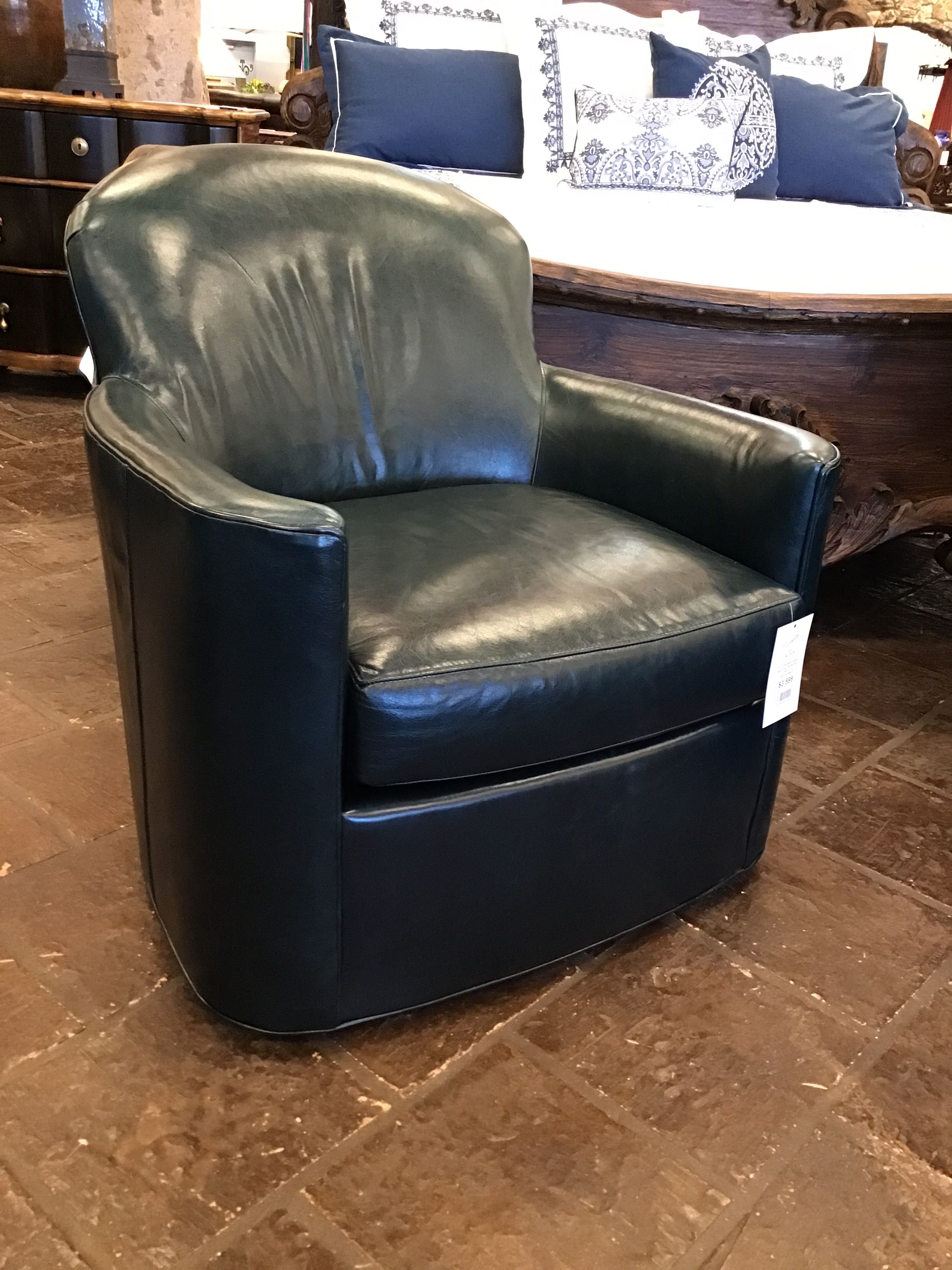 Blue leather armchair on a tiled floor with a blurred background