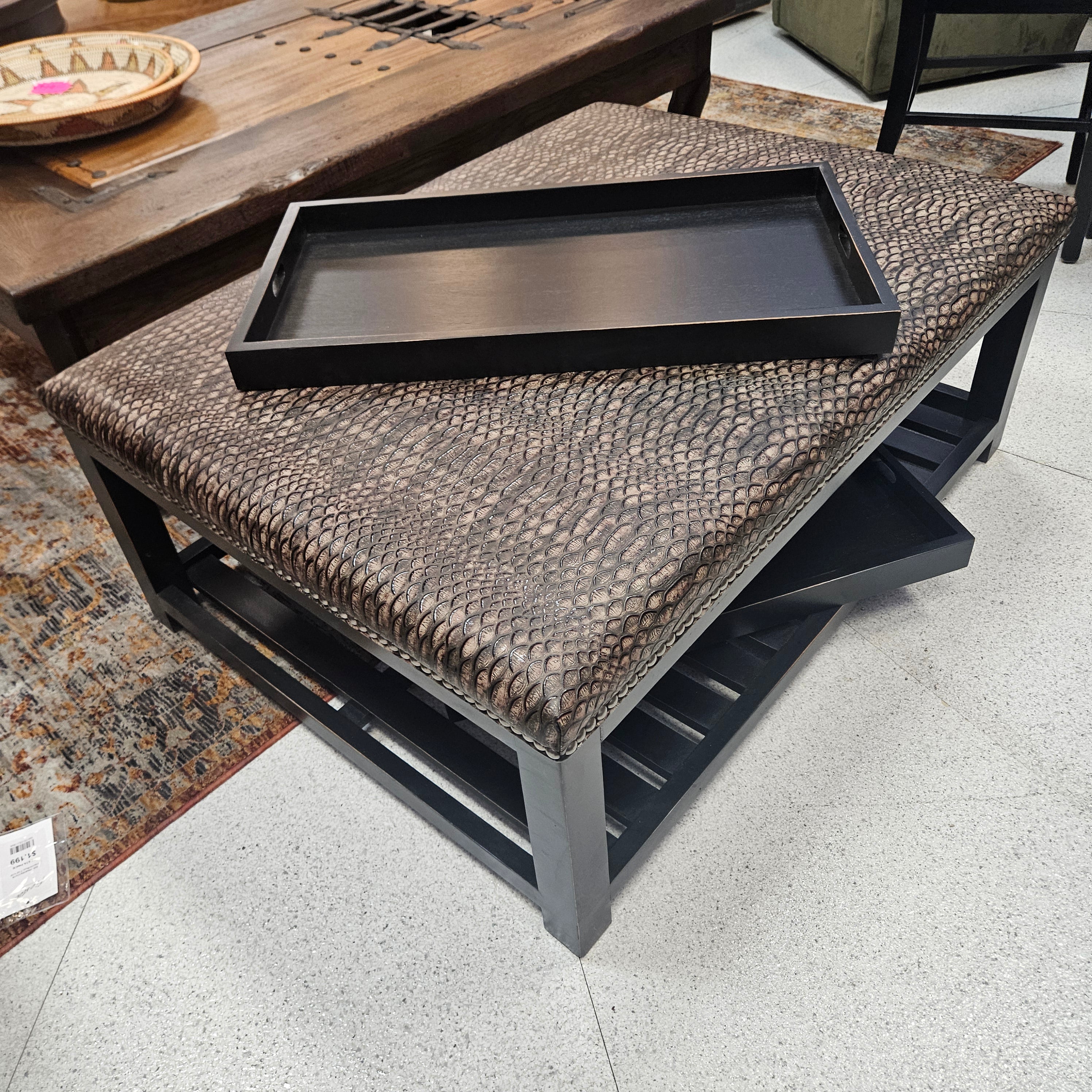 Decorative pillow with textured surface and black frame on a chair