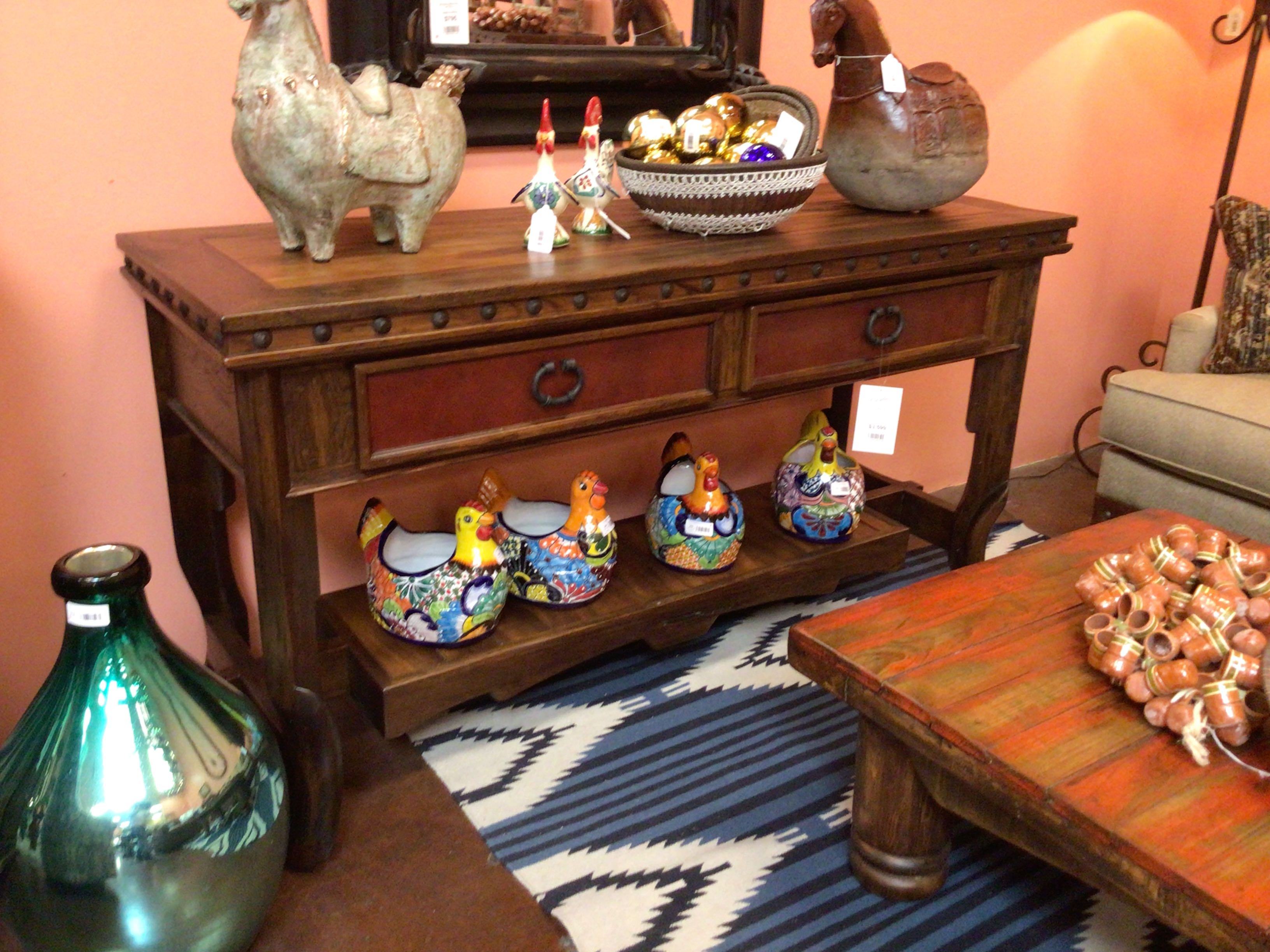 Wooden console table with decorative items in a room setting