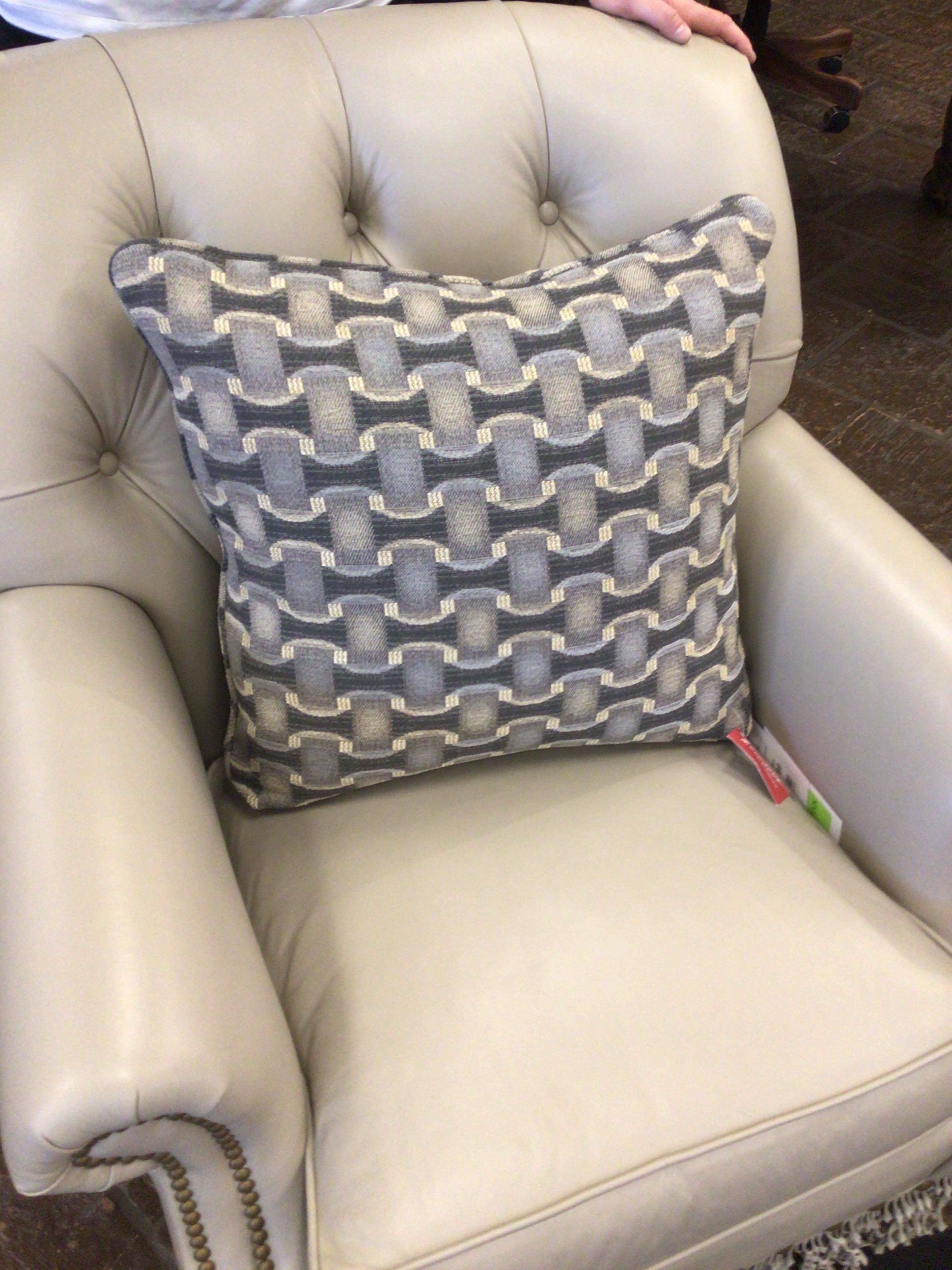 Patterned pillow on a beige armchair