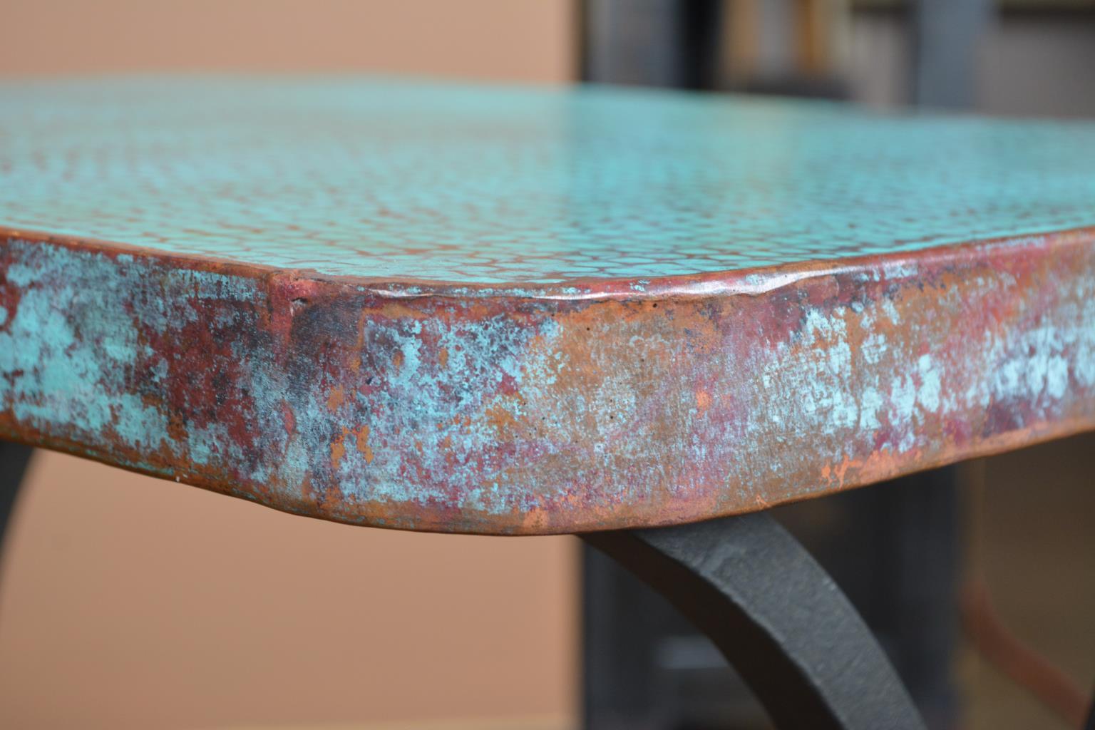 Close-up of a turquoise metal surface with a blurred background