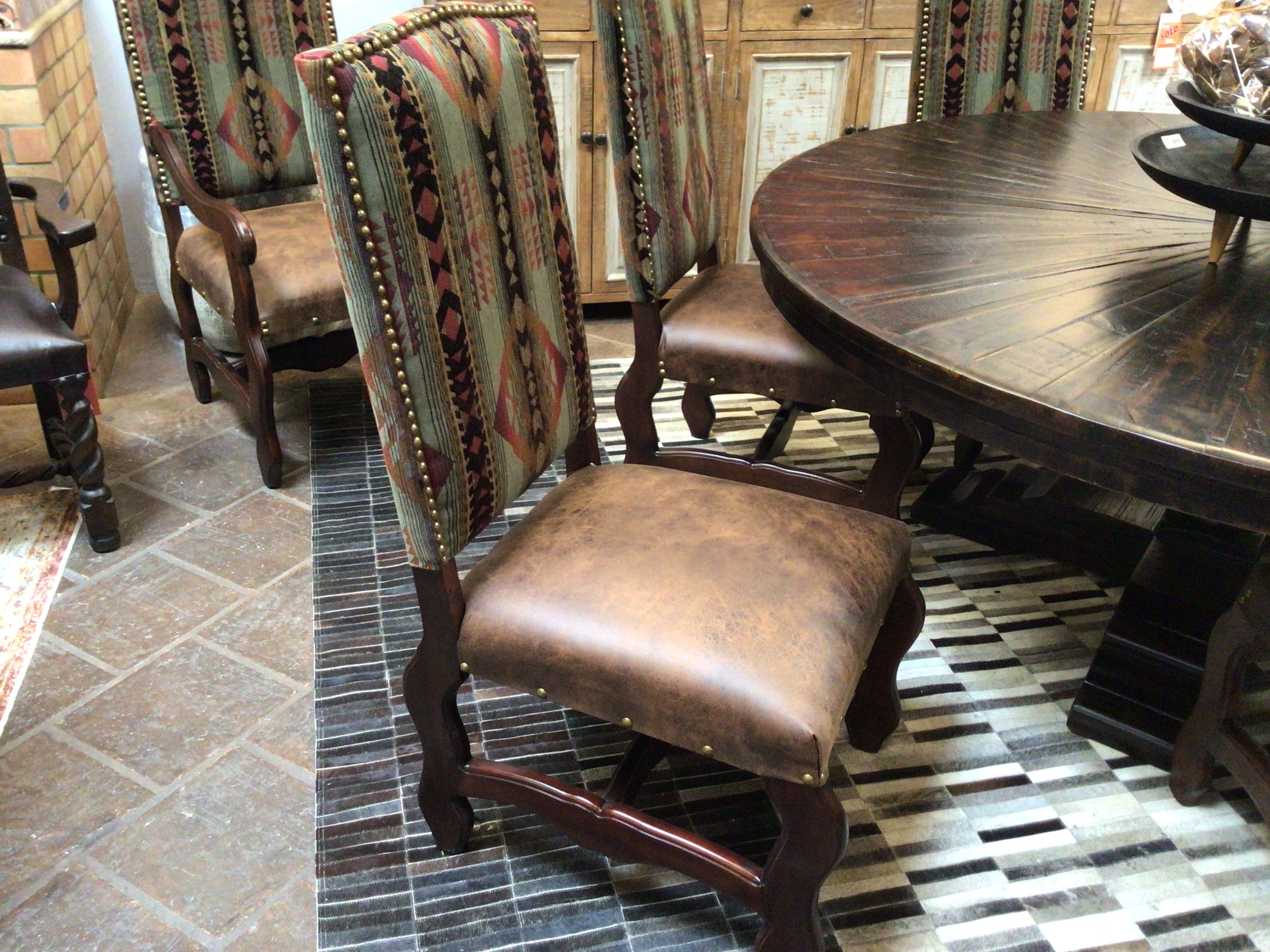 Dining room with wooden table and chairs on a patterned rug