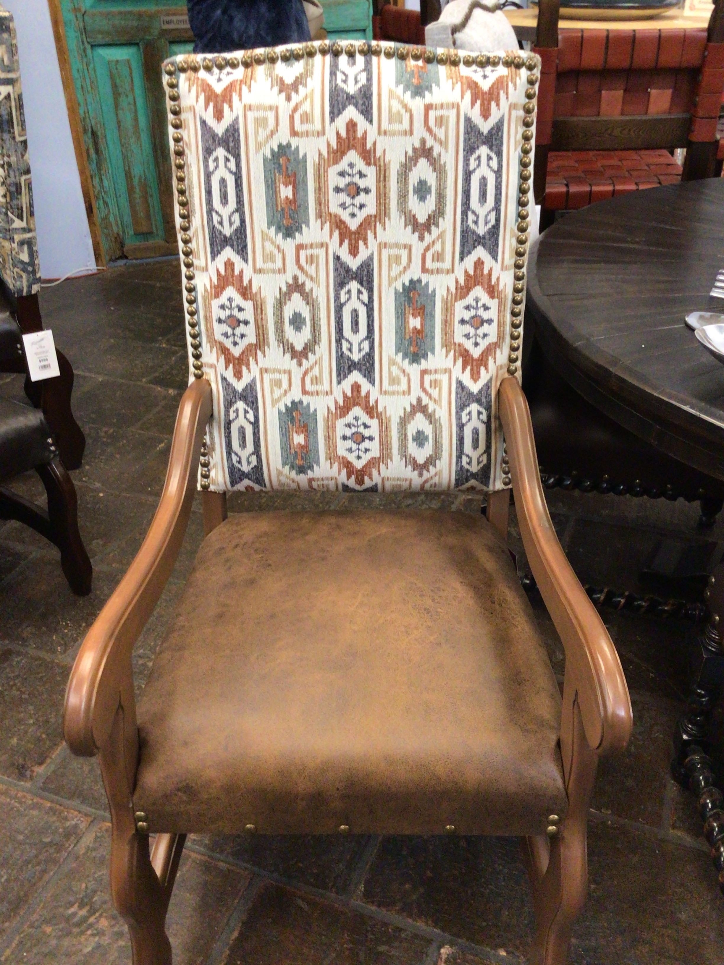 Chair with patterned backrest and brown seat in a room setting